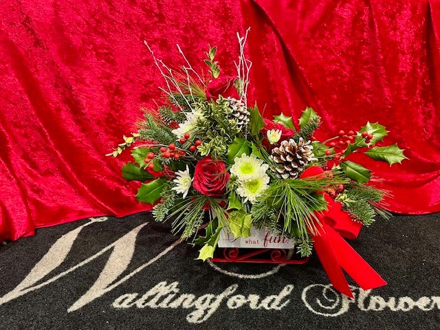 SLEIGH BELLS BOUQUET - Sleigh Bells is designed in a charming white sleigh filled with winter greens, red and white flowers, berries and pinecones. The sleigh can be refilled for years to come. 