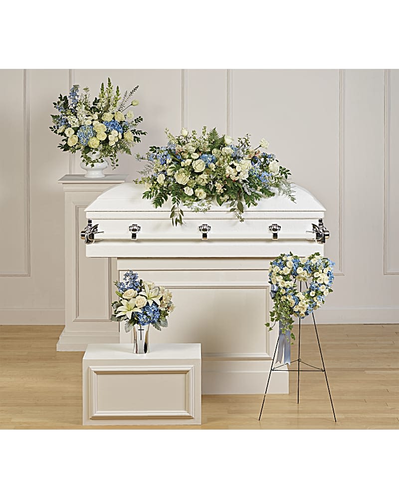 Tender Remembrance Collection - Featuring four hand-made sympathy pieces, this breathtaking collection of sky blue and pure white blooms is a touching tribute to your tender memories. Tender Remembrance Collection includes the following four sympathy set pieces: Tender Remembrance Casket Spray, Pure Heart, Treasured And Beloved Bouquet DX, Teleflora's Skies Of Remembrance Bouquet DX