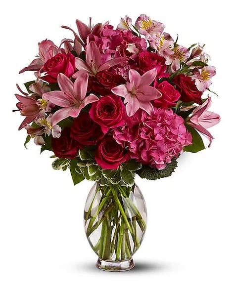 Head Over Heels - Is your mother so sweet that everyone falls in love with her? She''ll love this breathtakingly adorable arrangement of red blossoms - it''s two feet tall. A mix of fresh pink and red flowers such as roses, Asiatic lilies, hydrangea and alstroemeria is delivered in a large tinted vase.     