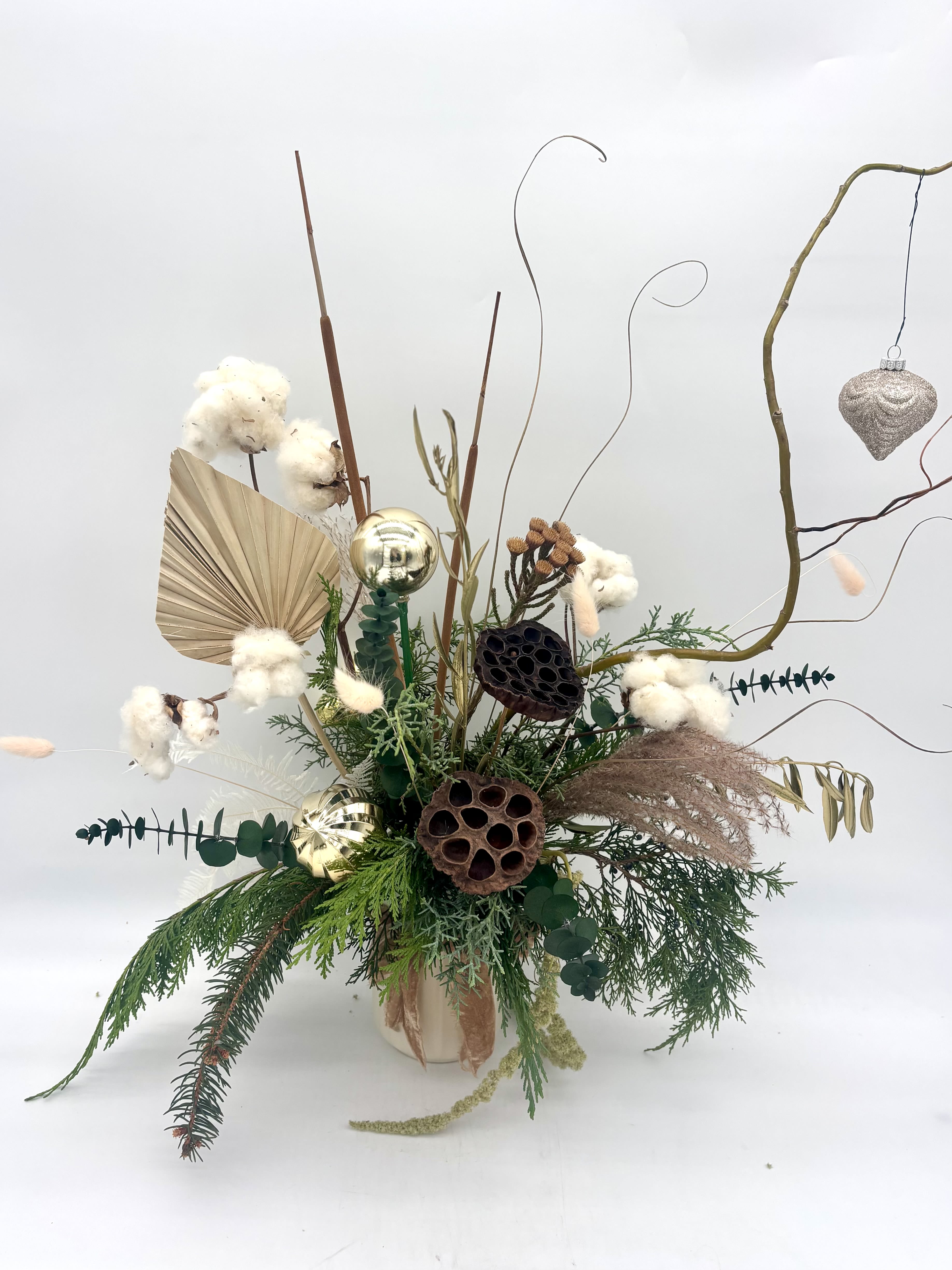 Snow Kissed Evergreens - Whimsical and natural winter inspired vase arrangement. Filled with fresh evergreens and dried material. Bringing the beauty of nature inside. Upgrade to Deluxe to add fresh flowers. Designers can substitute based on available product. 