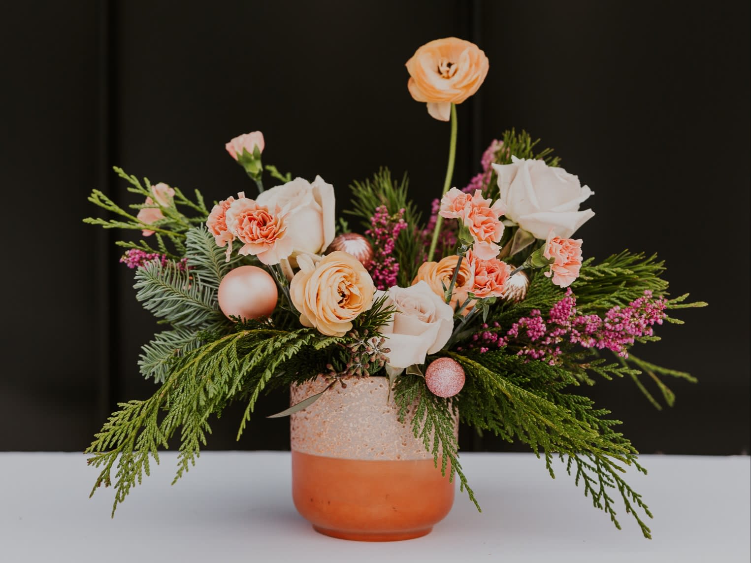 Fun Holiday - At Forage and Floral we love pink! What better way to show you than to design a pink holiday arrangement. Get this for your not so traditional family or friend. Comes with festive winter greens and ornaments.