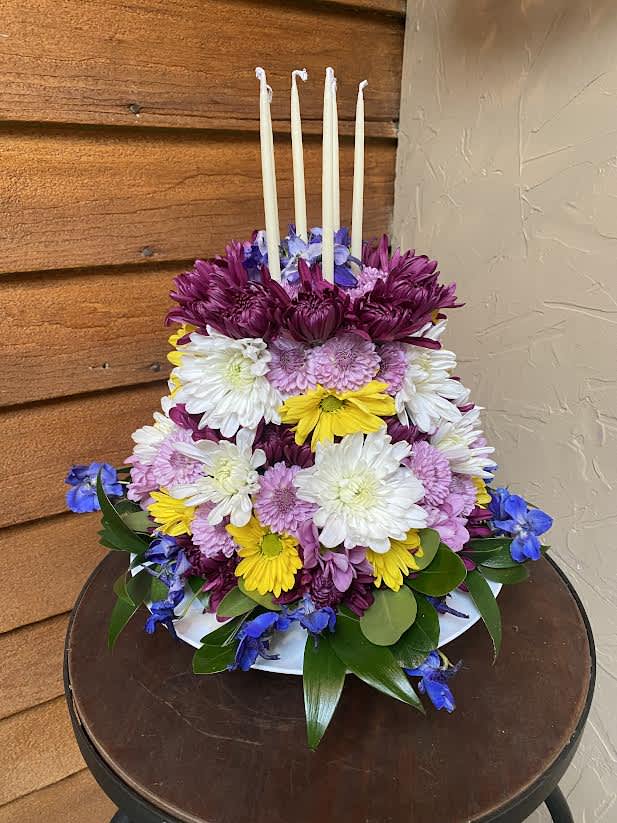Celebration Cake - Adorable way to celebrate any occasion. Designer selected flowers. 6 Candles included. 2 tiers of beauty!