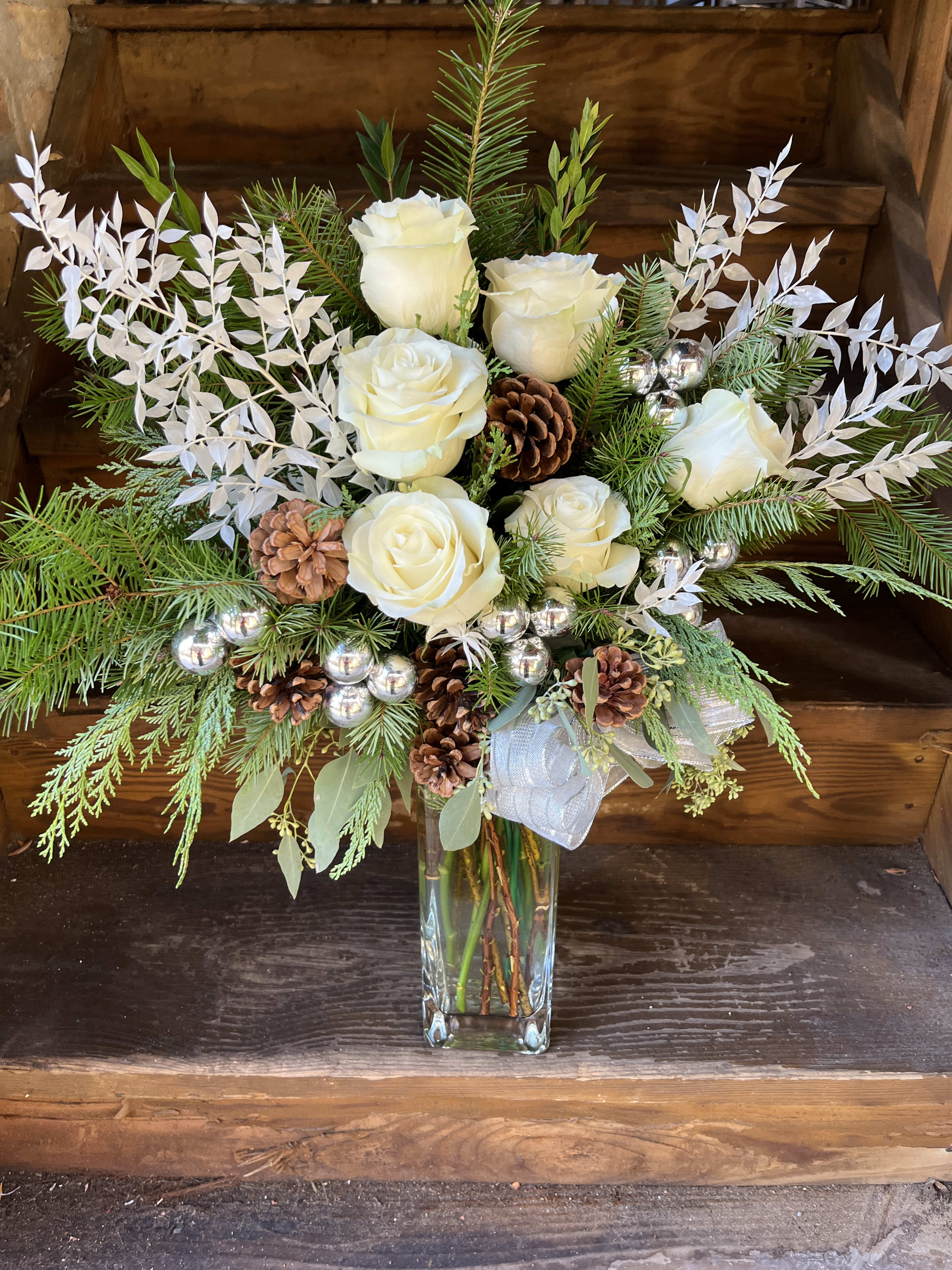 Extra Tall Wintery White Arrangement - PERFECT for YOUR FOYER.  A Dramatic Tall front facing arrangement of white roses, pinecones, silver bells and evergreens.
