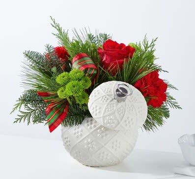 Sweater Weather Ornament Ball  - Send a wonderful giftable keepsake - the white ornament ball. It comes complete with a lid to make a perfect holiday jar. This is a Designer's Choice arrangement with seasonal flowers, evergreens, ribbon and pinecones. Style of ornament ball varies. Designers can substitute based on available product.