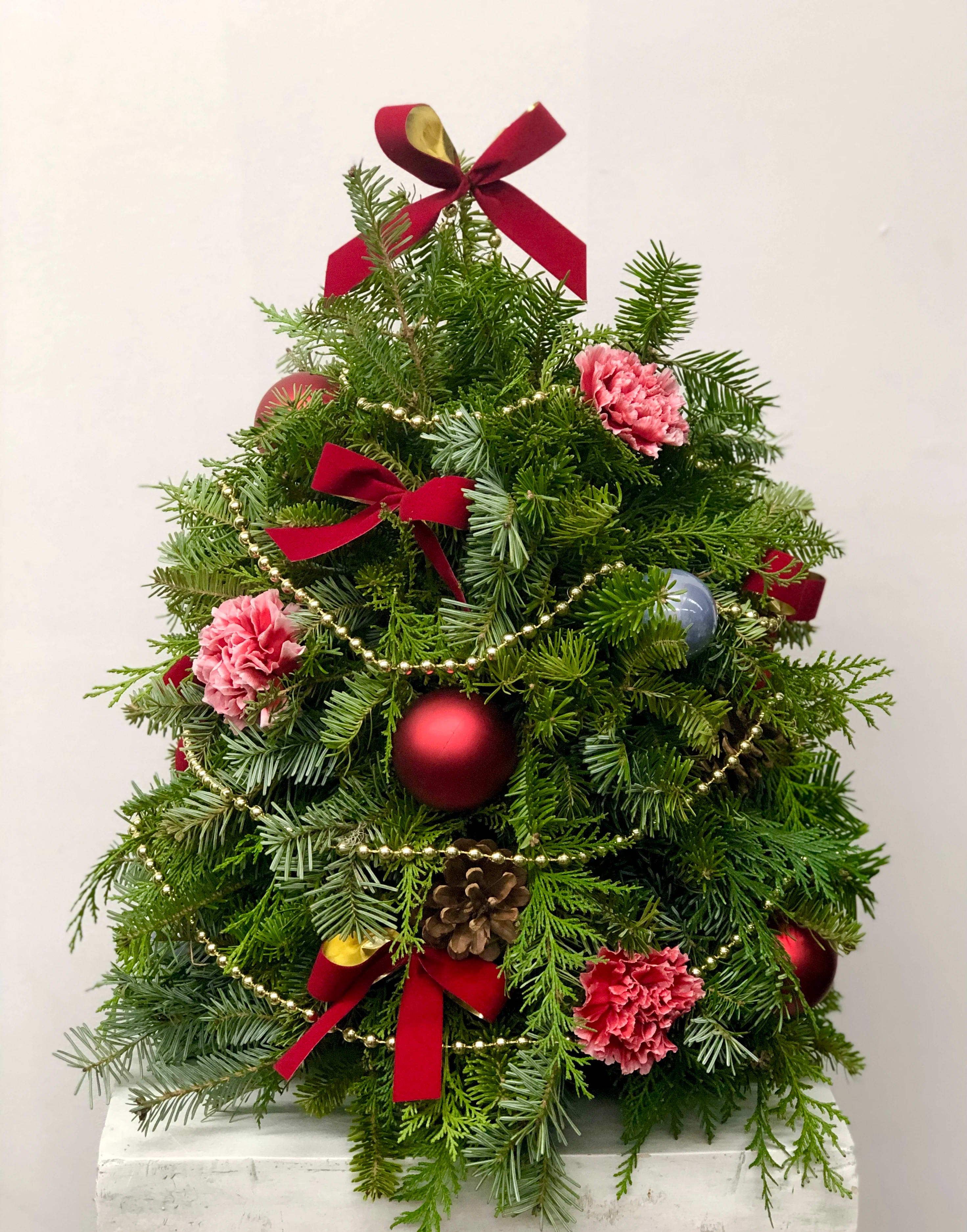 Oh Christmas Tree - An arrangement of evergreens and flowers create this beautiful tree.  Decorated with flowers and ornaments.