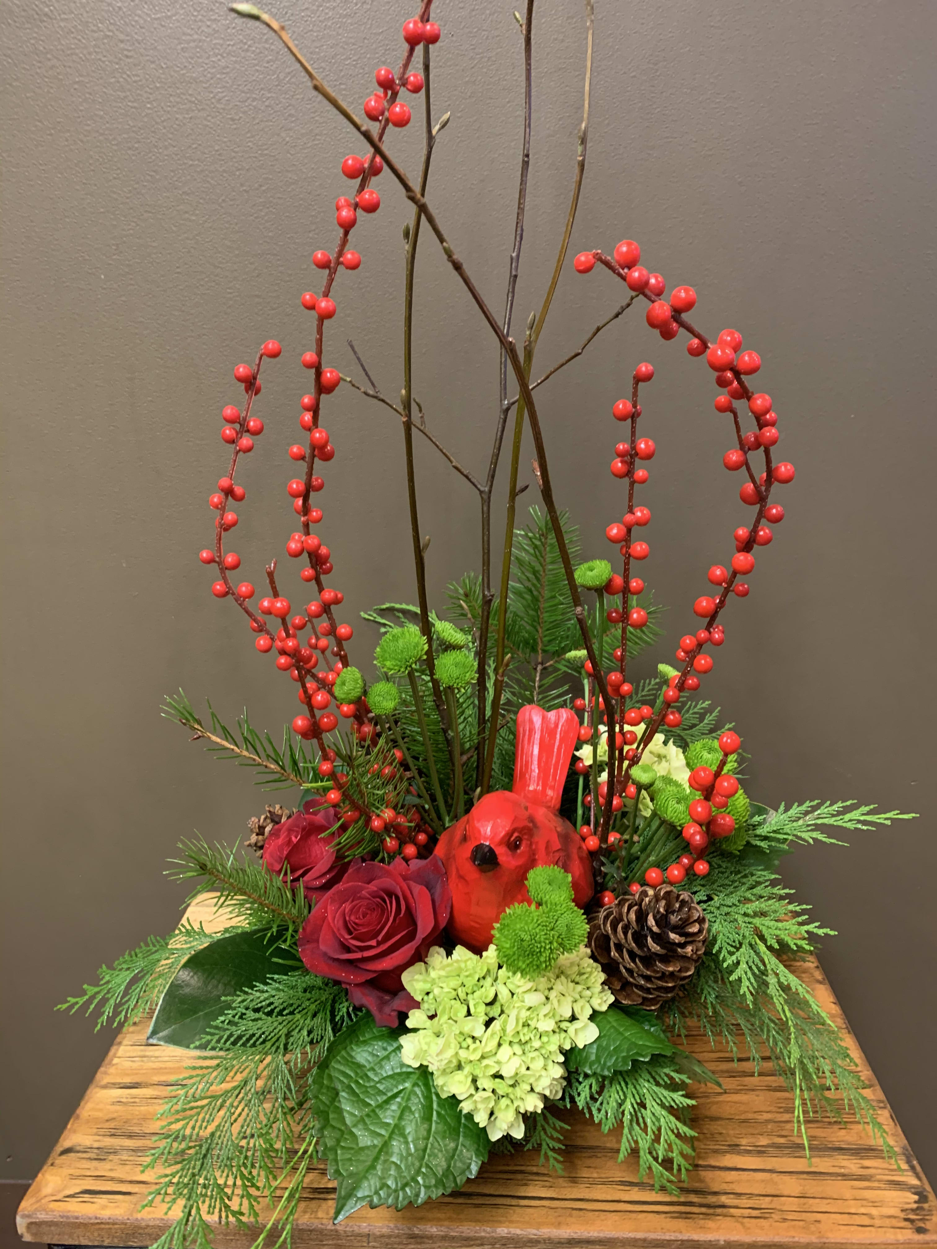 Cardinal Christmas  - A beautiful cardinal nestled in an arrangement of red roses, green hydrangea, red berries, alder branches and green button mums. 