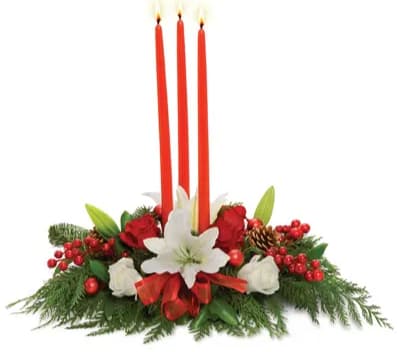 Trinity Candle Centerpiece - A trio of red taper candles hover above the perfect holiday centerpiece of white lilies, red roses, holiday trim, berries and pine boughs.