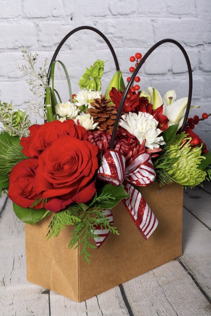 Bag of Blossoms ~ Christmas Edition - Our popular bag of blossoms comes with a festive holiday twist! This cute bag is filled with the colors of Christmas and includes roses, tulips, hydrangea, alstroemeria, chrysanthemums, hypericum berries, and other seasonal flowers. Great gift for desk spaces and kitchen tables!!