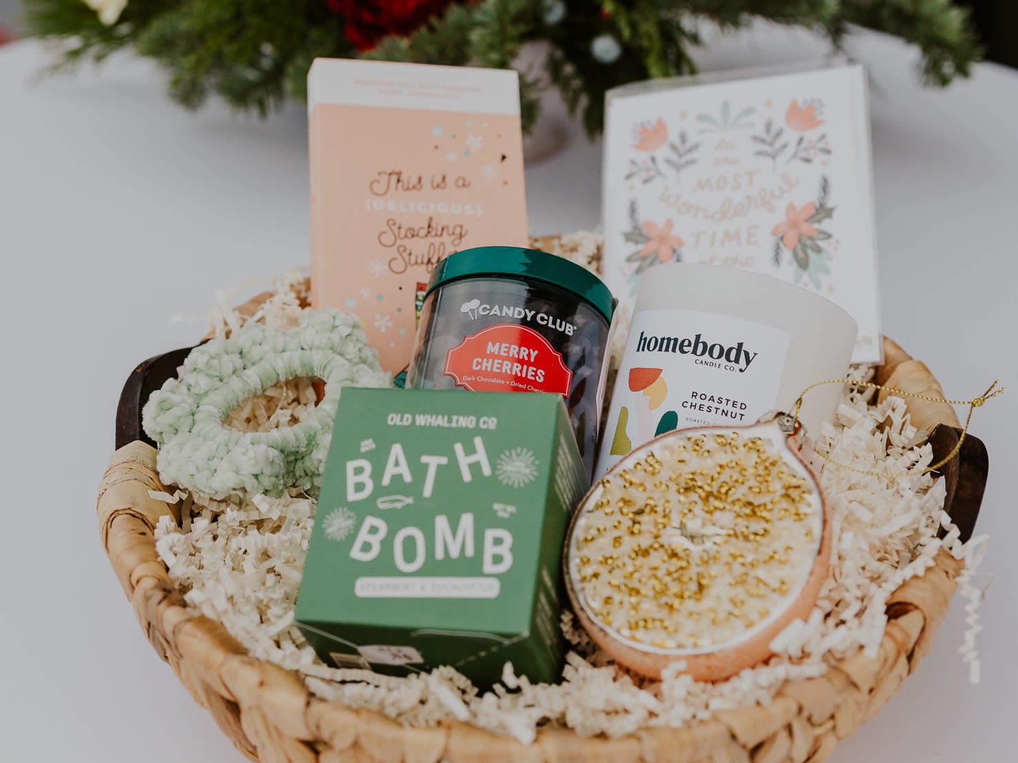 Holiday Gift Basket  - The Holiday Gift Basket includes a bath bomb, holiday scent candle, face mask, chapstick, holiday candy, body butter, ornament and a holiday greeting card.