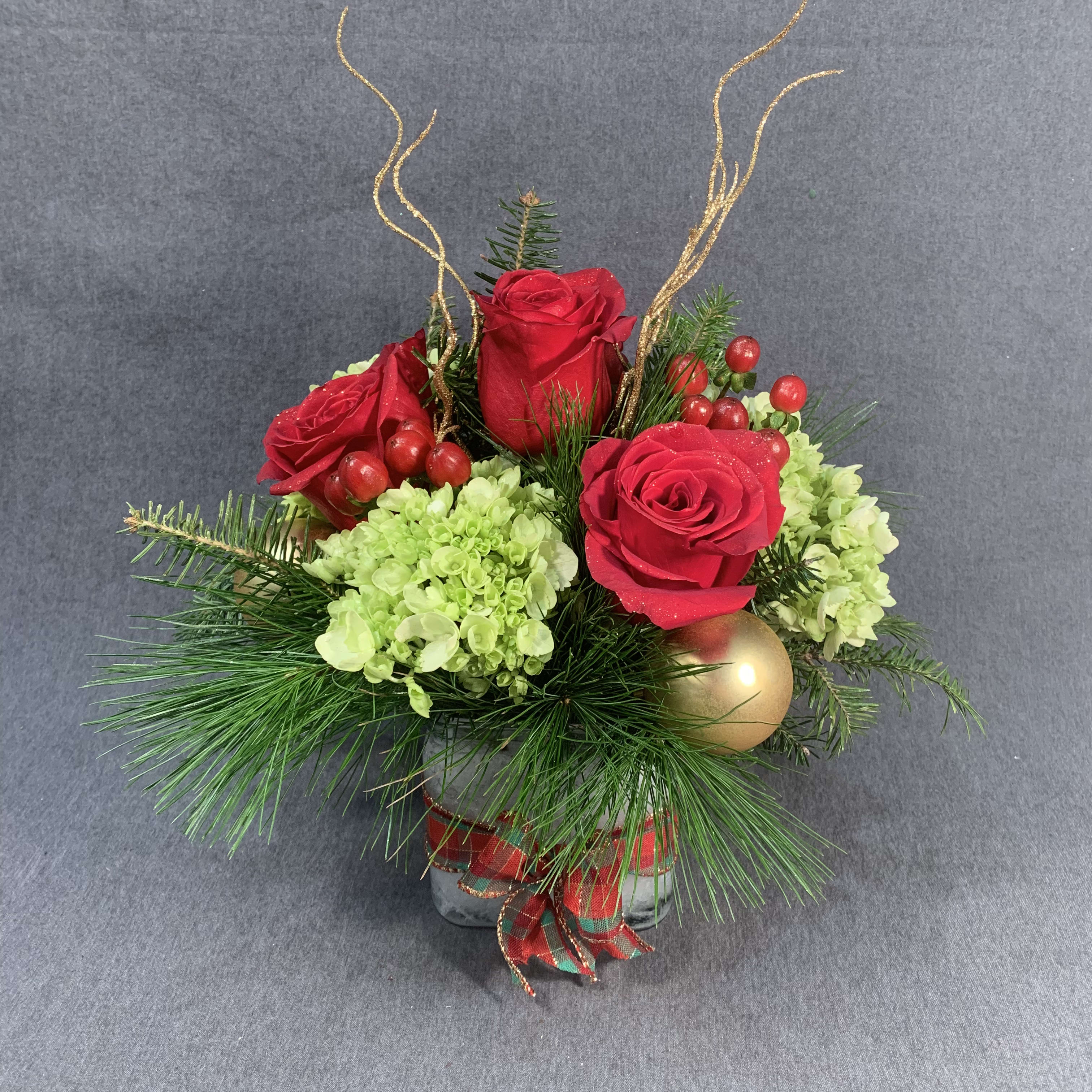 Holiday Happiness - This modern style Christmas arrangement is the perfect arrangement for the person who prefers elevated decor. Hydrangeas, roses, and more.