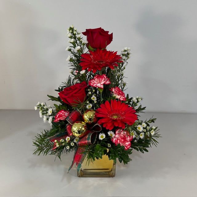 Touch of Gold - This elegant arrangement in a Gold 4x4 Glass Cube Vase, features Red Roses, Red Gerbera Daisies, Peppermin Mini Carnations
