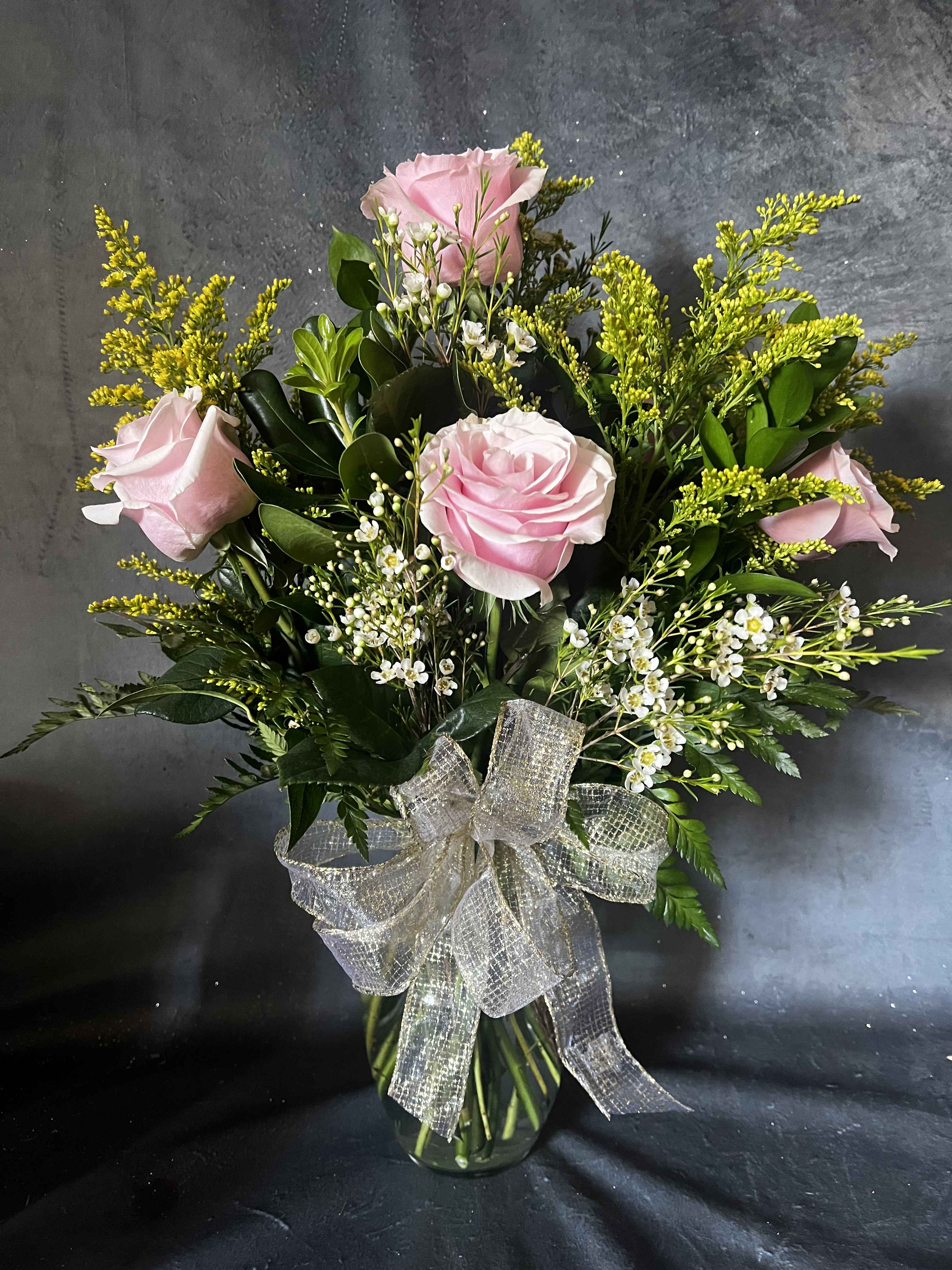 Pink Roses Vase - The perfect pink dozen is a beautiful way to say I love you or Happy Birthday!   Our pretty pink roses arrangements speak volumes! Beautifully hand-arranged with Pink roses, Baby's Breath and Greenery in a vase.   .