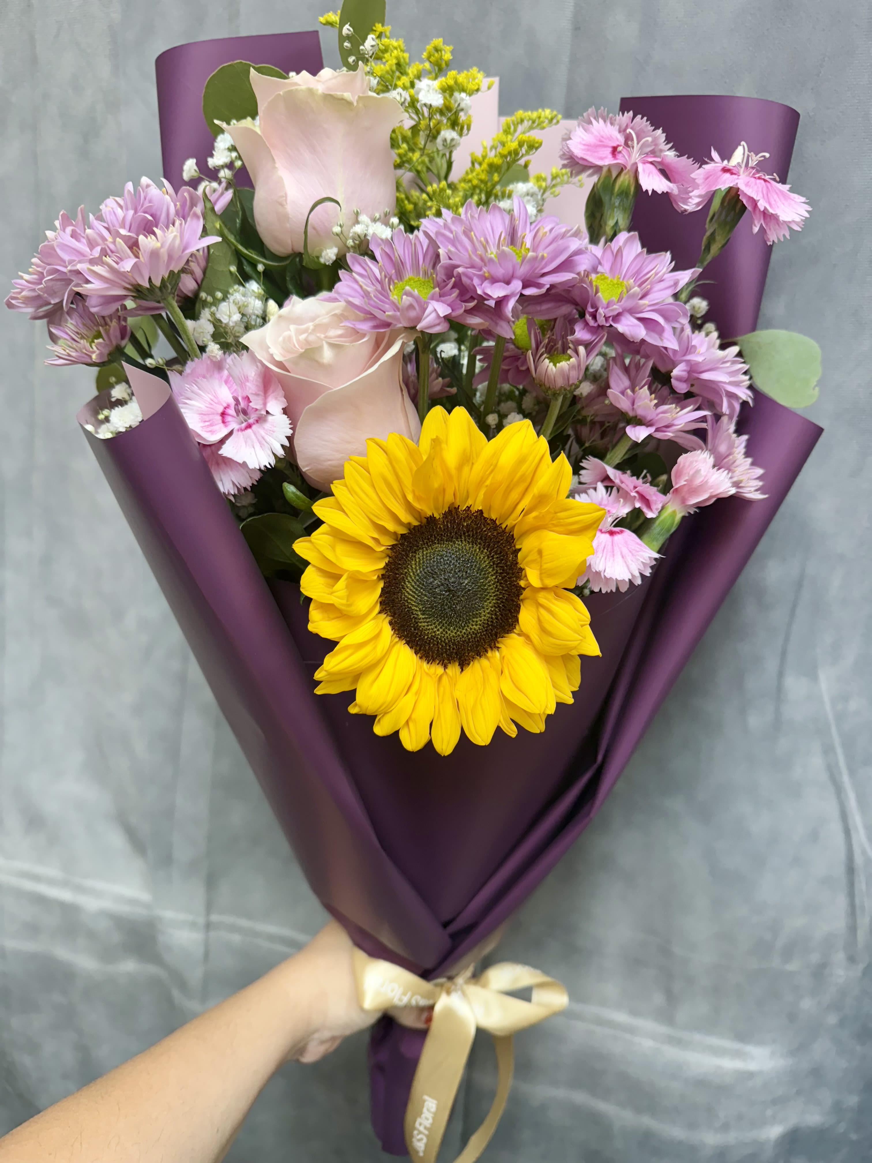 Lavender sunshine bouquet - A delightful fusion of sunny vibrancy and lavender tones with pink toned flowers ideal for bightening up any space or special moment.