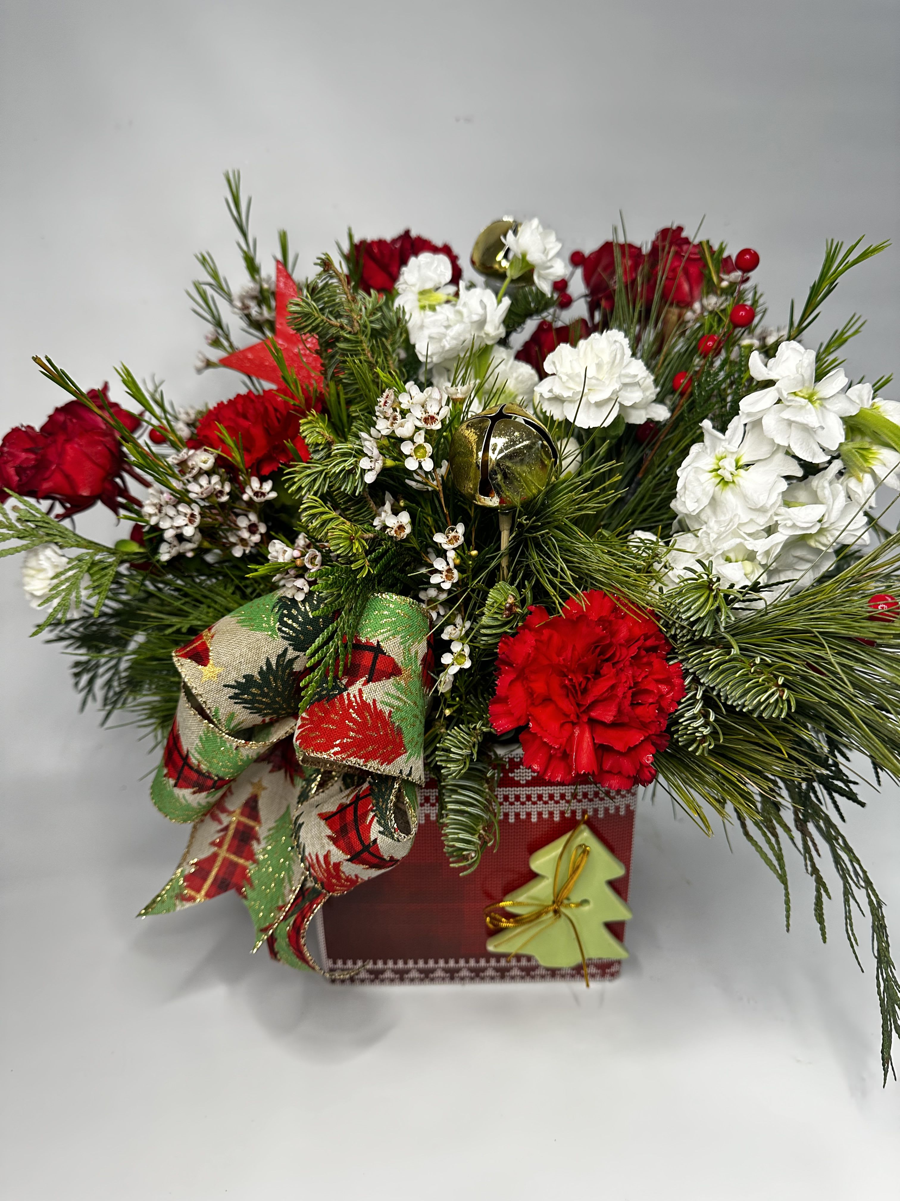 Nordic Jingle - Nordic sweater inspired container filled with seasonal red and white flowers,fragrant pines, snow covered pinecones and Jingle bells