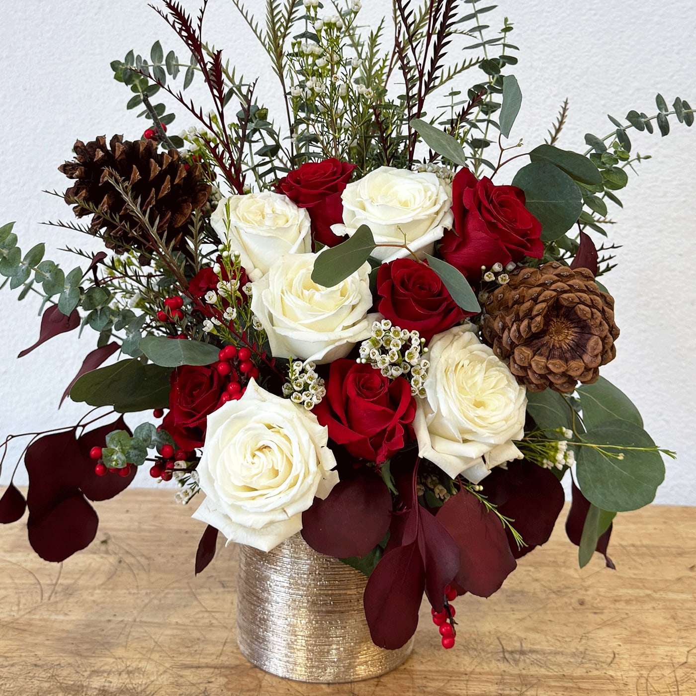 CHRISTMAS GOLD  - CHRISTMAS GOLD  - PINECONES, RED ROSES, WHITE ROSES, EUK BABY BLLUE, WAXFLOWERS, SILVER DOLLAR EUK, WINTER GREENERY