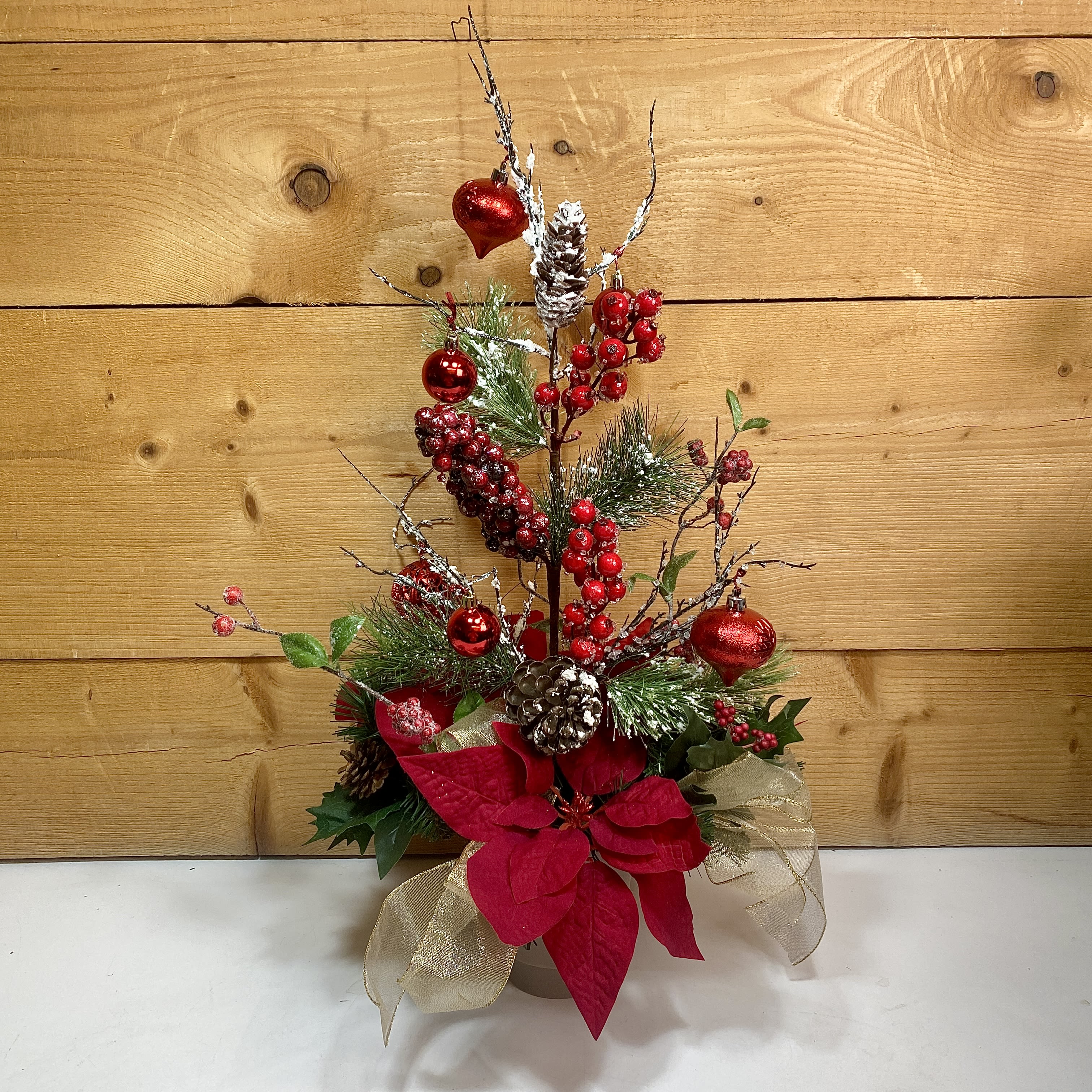 Scarlet Symphony Silk Arrangement - Our Scarlet Symphony Silk Arrangement is a beautiful artificial holiday arrangement that you can keep and use for many years to come! This beautiful design includes artificial winter greens, shimmering red ornaments, faux poinsettias, and more winter accents that'll be sure to make your home perfectly festive for the holidays! Dimensions: W 18&quot;x H 26&quot;