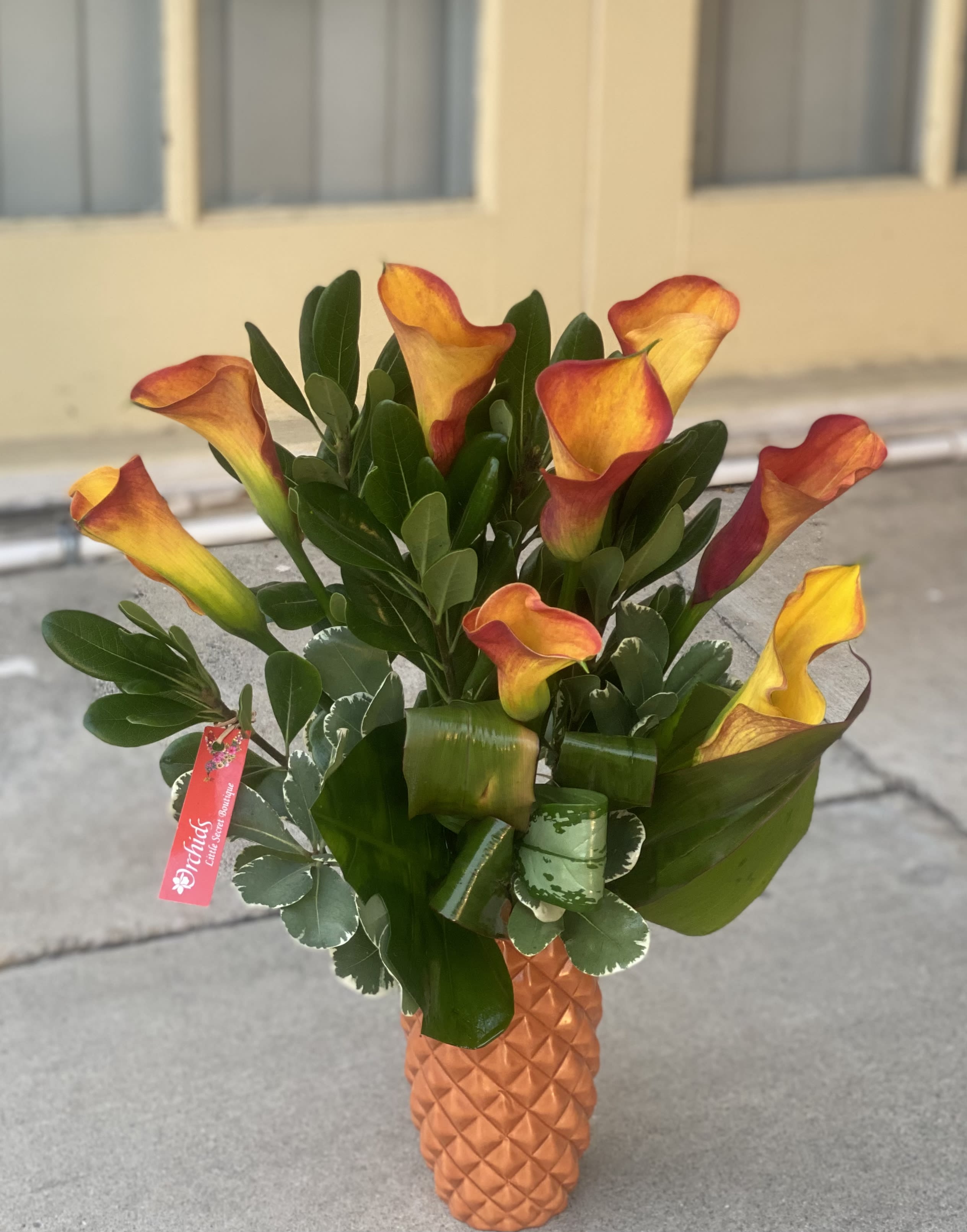 Mini Calla Lily Mango / Orange Bouquet  AVAILABLE NOW SAME DAY DELIVERY!  - Beautiful mango calla lilies arranged in a in a matte orange 8"H ceramic vase. Wow your recipient  with this unique and elegant arrangement!  Bouquet is approx. 24"H  