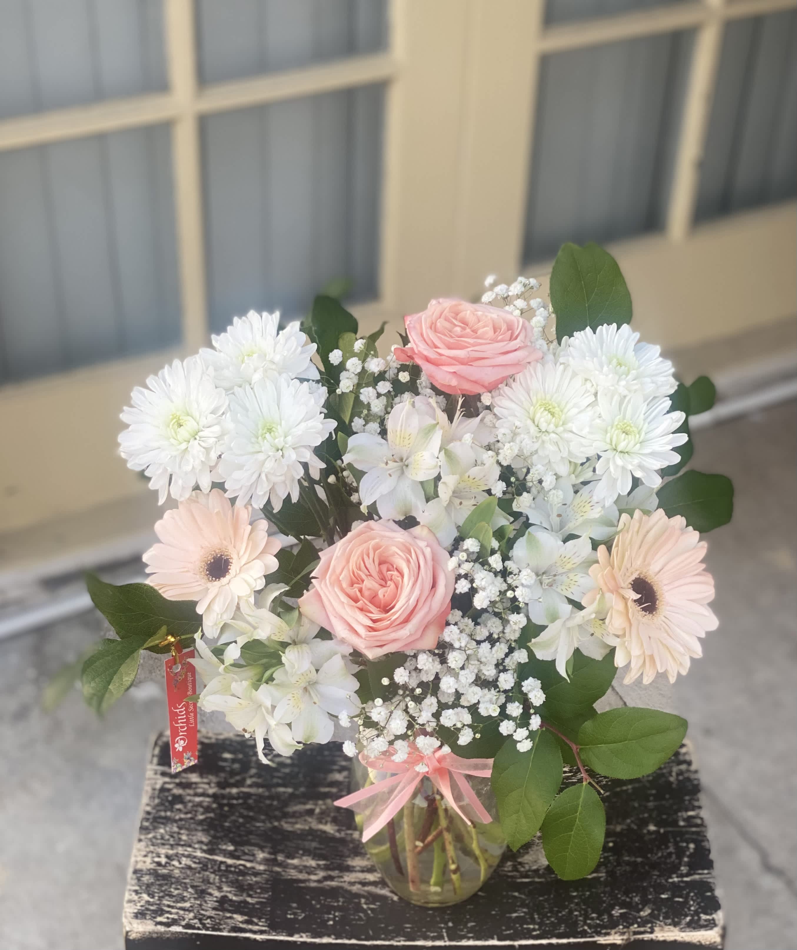 Brilliant White &amp; Peach Rose Bouquet - Delight your recipient with Orchids Little Secret Boutique Brilliant peach roses surrounded by white blooms, and lush greens, beautifully arranged in a "7 clear glass vase.  A beautiful and soft bouquet that loved ones will adore for any occasion.
