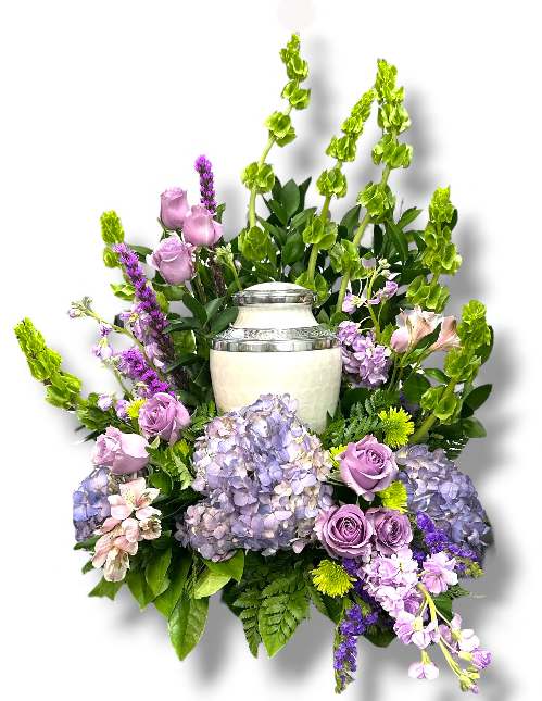 Purple and Lavender Urn or Photo Tribute - Purple and Lavender Urn or Photo Tribute is a beautifully crafted arrangement that combines soft hues and lush textures to create a heartfelt tribute. Featuring delicate Bells of Ireland, fragrant lavender stock, elegant white Alstroemeria, and full white hydrangea, this arrangement is accented with purple Statice, classic lavender roses, vibrant green button mums, all surrounded by rich, mixed greens. Perfect for honoring loved ones, this arrangement exudes tranquility, grace, and a touch of Irish charm, making it a meaningful centerpiece for remembrance or celebration of life.  (Urn or Photo not included.)