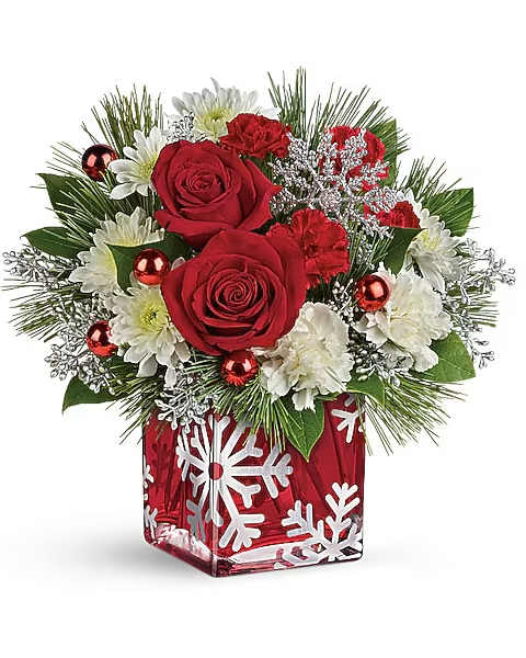 Silver Snowflakes  - Silver snowflakes captivate beneath this lush holiday arrangement of rich red roses nestled amongst snow white blooms. Hand-decorated, the crimson glass cube will be a favorite vase and candleholder for many Christmases to come! This elegant bouquet includes red roses, white carnations, white cushion spray chrysanthemums, seeded eucalyptus, white pine and lemon leaf.  To guarantee the freshest bouquet possible, our florists may replace some stems in your arrangement which could differ in color and variety. Any substitution made will be similar to the original design and be of equal or greater value. Due to availability, the vase that arrives with your flowers may be different than the one shown on our website.