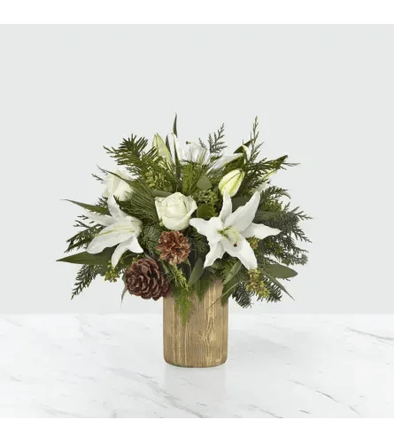 Joyful Greetings Bouquet - The Joyous Greetings Bouquet is an elegant collection of ivory, cream, and green hues. Handcrafted with classic roses, Oriental lilies, and assorted Christmas greens, this bouquet brings the holiday cheer with each petal. This collection of flowers, set in a gold bark ceramic vase, instantly invites guest to share joy and the season’s greetings.  Please note the bouquet pictured reflects our original design.  If the exact flowers or container in this arrangement are not available, we will sub for the freshest available flowers equal to or greater in value and closest available container.