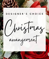 Designer's Choice Christmas Arrangement in a Vase - Surprise them with a stunning hand-designed seasonal arrangement full of fresh Christmas blooms! Leave it up to our expert designers who will hand-pick fresh holiday greenery and floral to create a one-of-a-kind vase arrangement that will wow.   Please note: Color palettes, florals, and design style will vary in each design. If you need a specific color design scheme or floral variety, please call 843-766-7807.