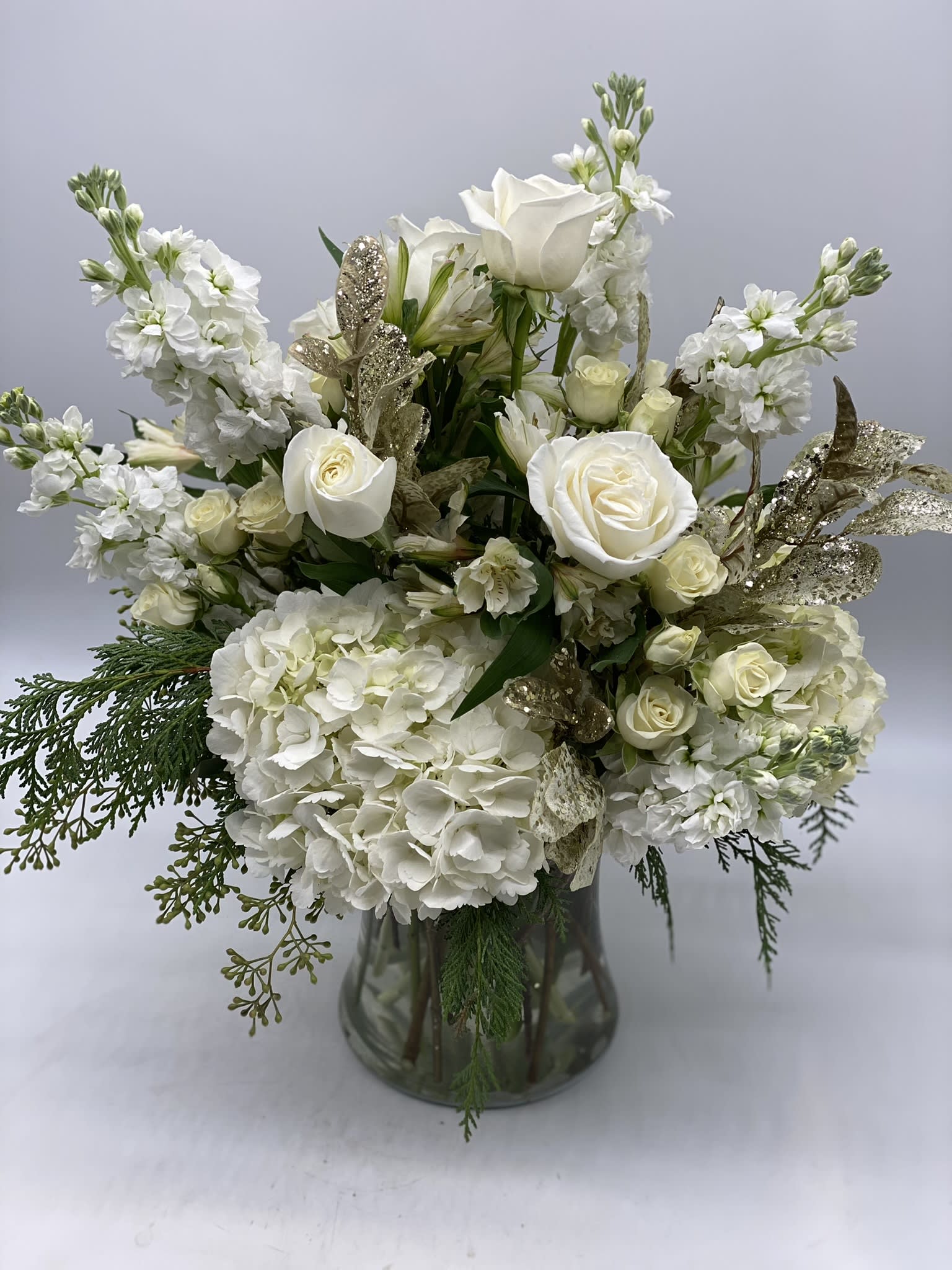 Winter Whites - This elegant arrangement is adorned with a seasonal mix of flowers. With soft white hues, this is a great gift for the new year!!!