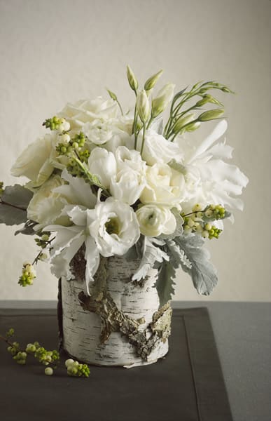 White Birch  - All white Christmas Flowers mixed with Christmas Greens, Berries, and White Accents Arranged in Birch Container. 