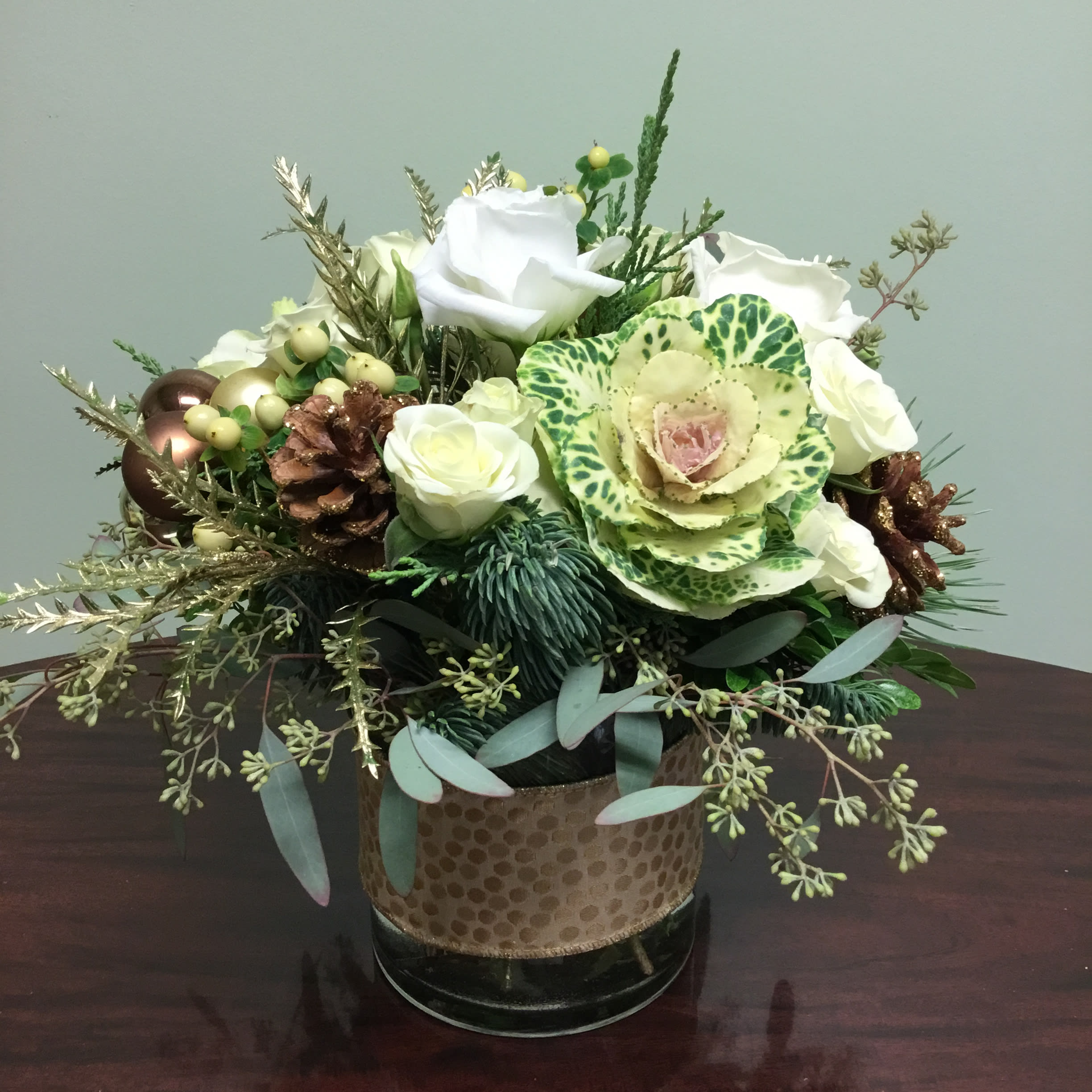 Eggnog CR36 - This arrangement filled with roses, spray roses and other ivory flowers with gold accents is a perfect toast to the holidays! 