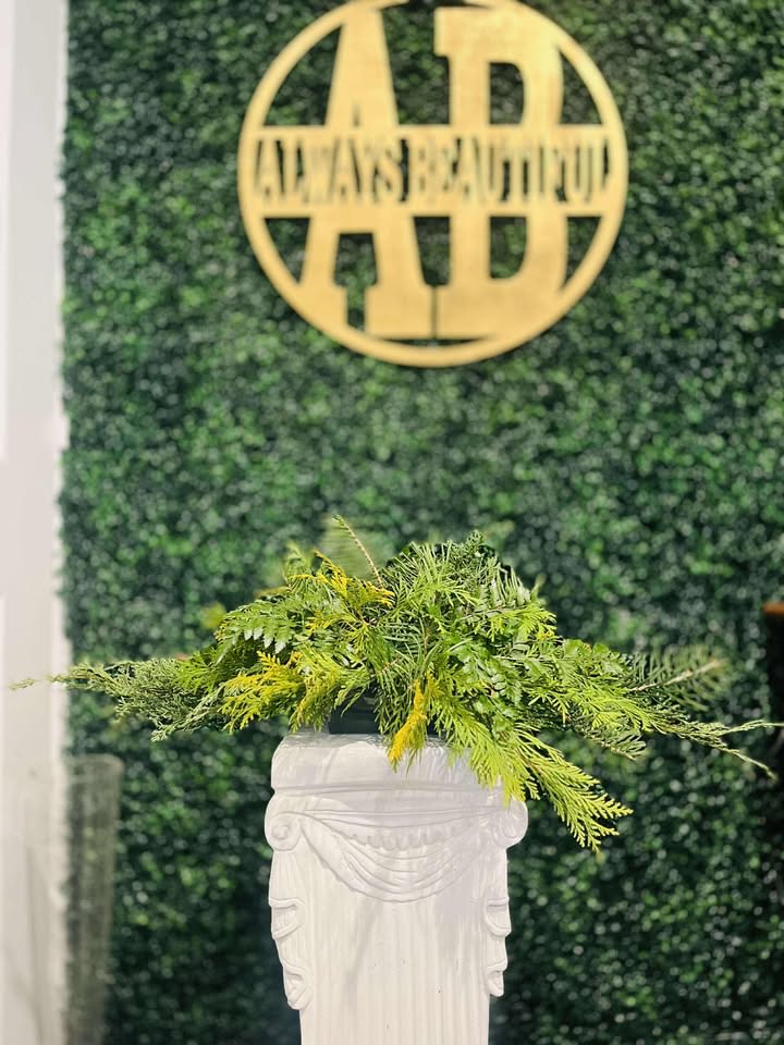 Christmas Centerpiece Greens - This Christmas centerpiece is a lush and elegant arrangement crafted entirely from vibrant Christmas greens. A rich mix of fragrant evergreen branches, including pine, fir, and spruce, creates a full, textured base, evoking the spirit of a winter forest, while the deep green of the boxwood enhances the centerpiece’s refined look. Subtle sprigs of cedar lend a soft, feathery texture, completing this natural and timeless holiday display. This centerpiece brings a peaceful, organic touch to your table, capturing the essence of Christmas with its evergreen beauty.