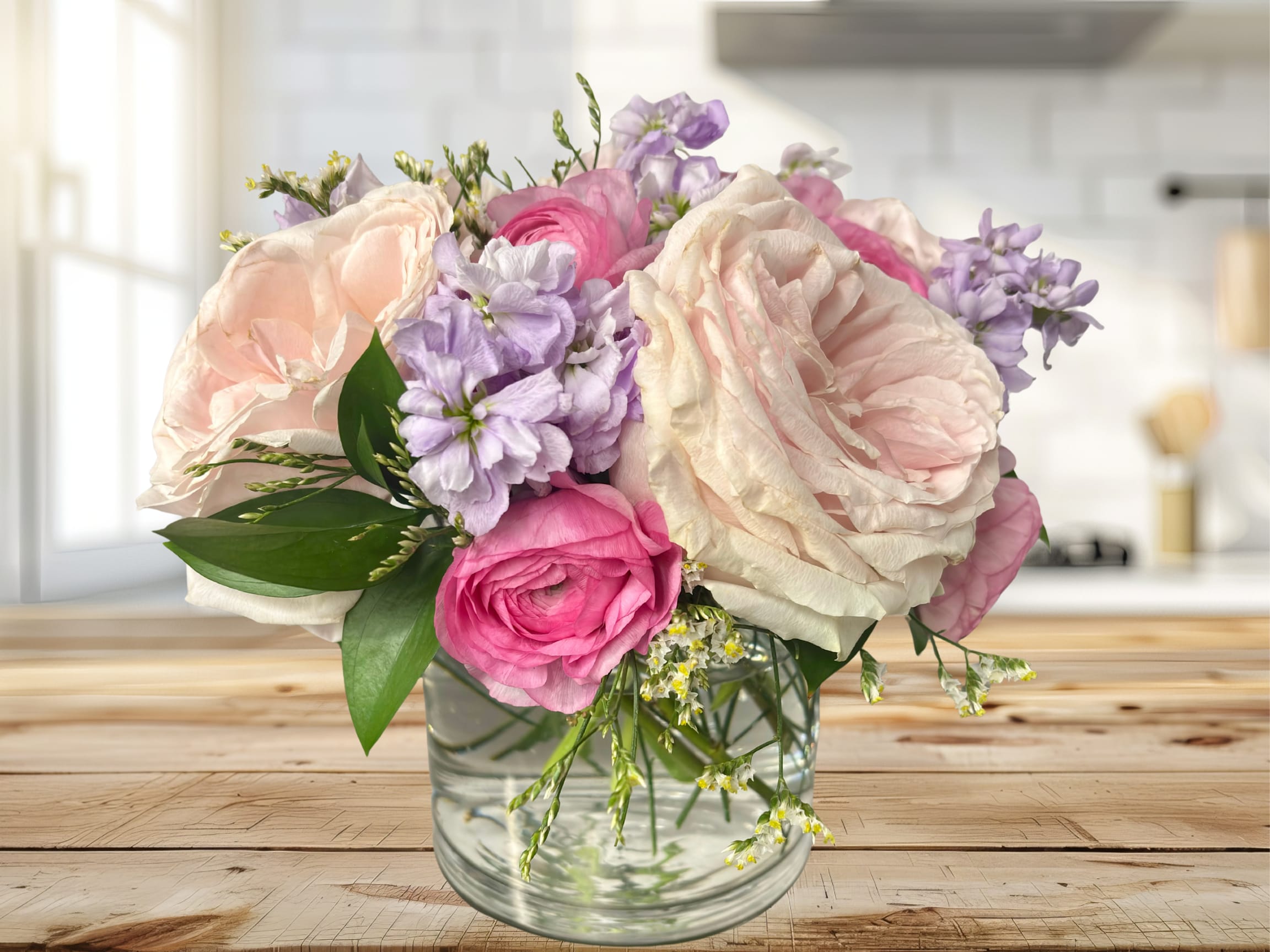 A Star is Born - Classically styled cylinder vase arrangement designed in a soft pastel color palette. Featuring premium florals with a spring feeling. 