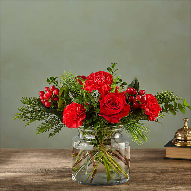 FTD Festive Perfume - Seductive and serious, this deep crimson bouquet of roses, carnations, boxwood and hypericum berries readies any room for a grown–up, classy soiree.  Please Note: The bouquet pictured reflects our original design for this product. While we always try to follow the color palette, we may replace stems to deliver the freshest bouquet possible, and we may sometimes need to use a different vase.