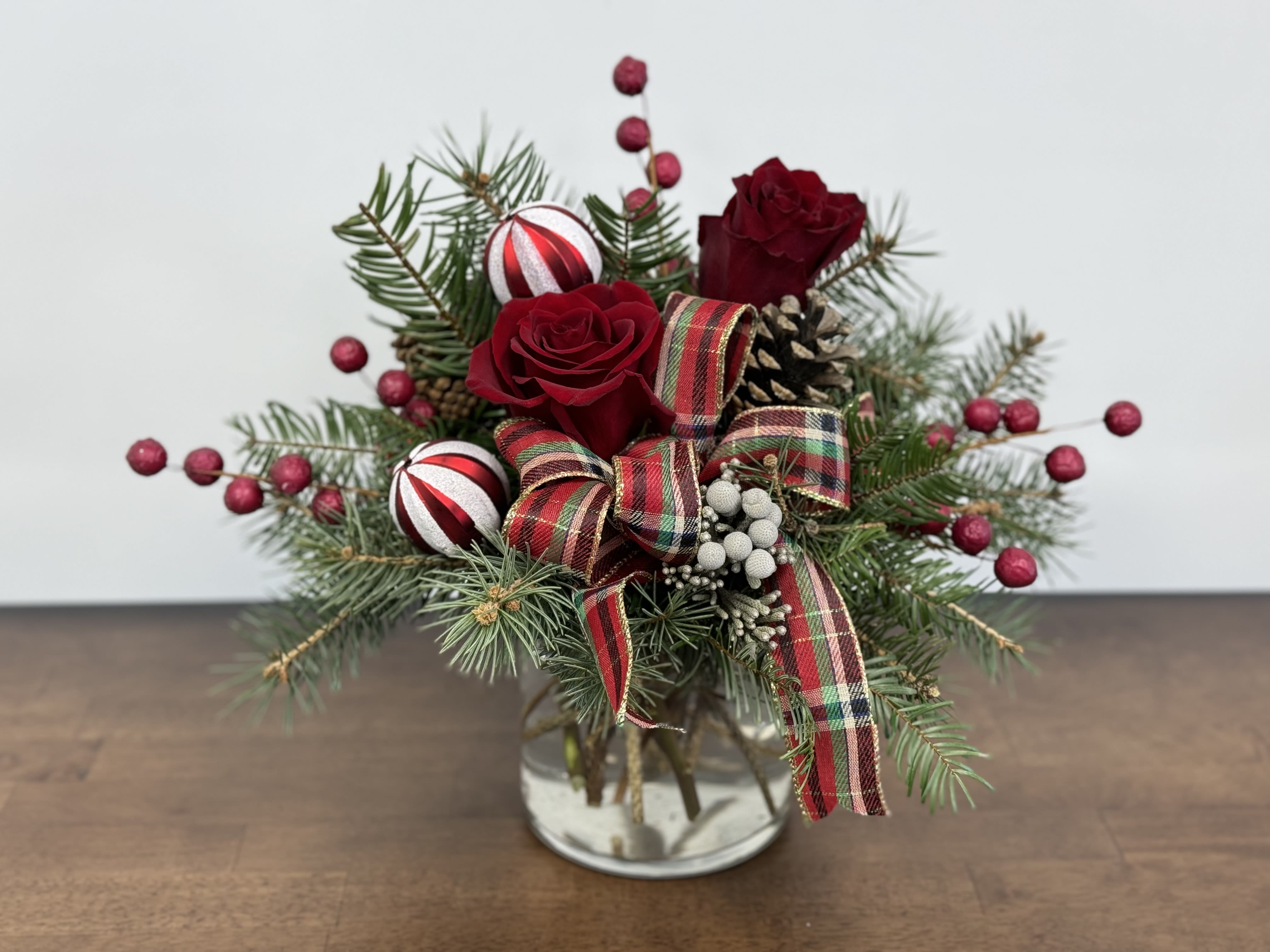 Holiday Cheer - Mixed pine greens with artificial berries and bows ensure that this gift will add to any holiday decor the whole season. 