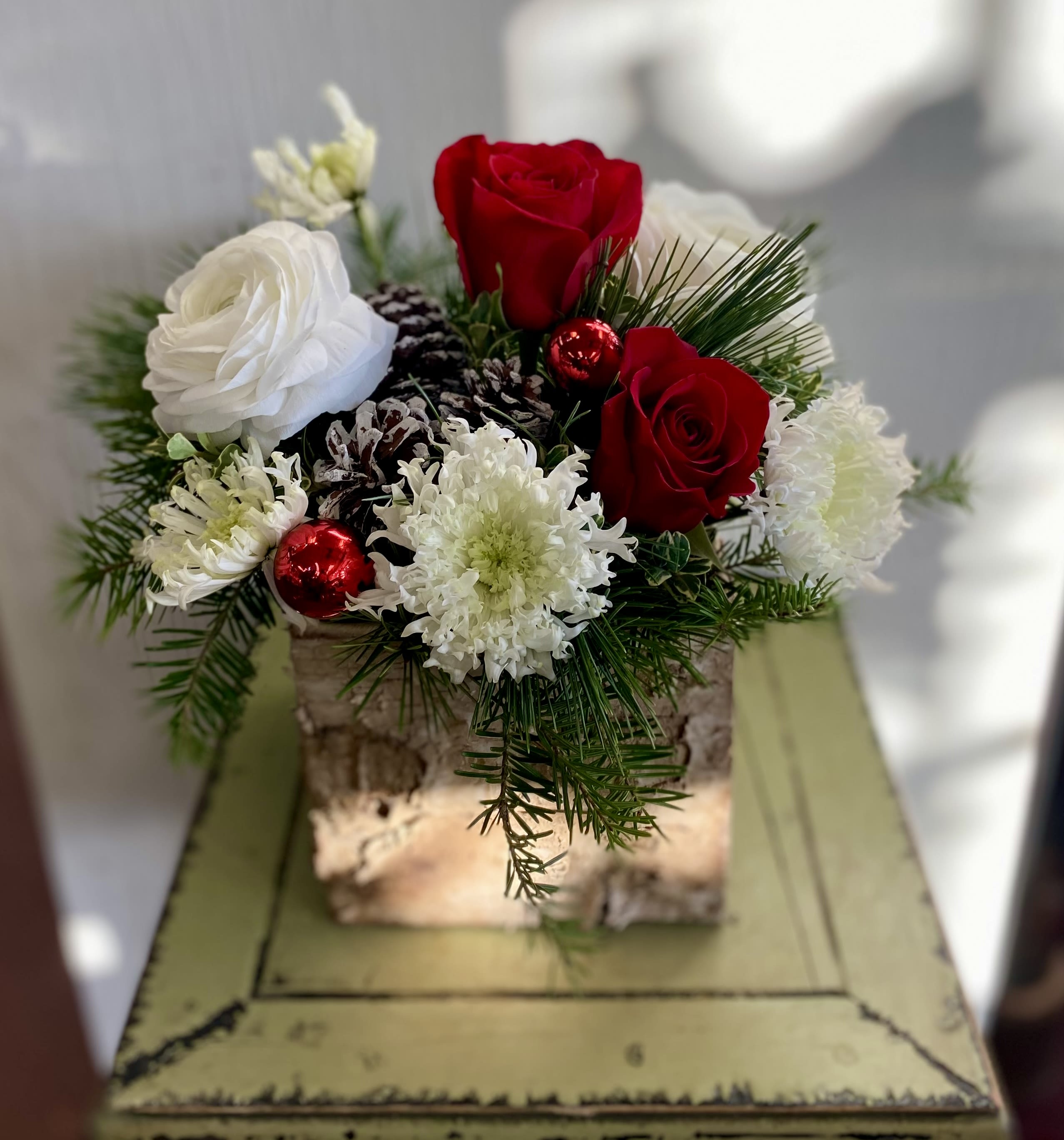 Winter is in the Air - Roses. Glorious ranunculus. Holiday greenery and trim. Just beautiful!