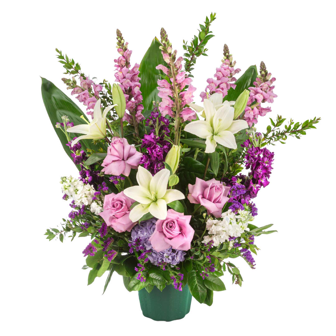 Purple Blessing - A purple and white sympathy basket featuring snapdragons, roses, lilies, and stock. This fragrant arrangement works for every type of funeral ceremony.