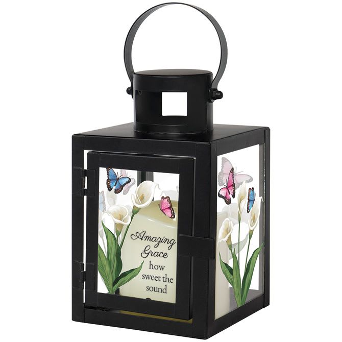 Sympathy Lantern 9.5" - Amazing Grace - Glass lantern with flameless LED candle; an artisan design to add ambiance and soft mood lighting to any space. -Useful décor for hanging or freestanding -Lettered sentiment on powder coated glass -A-mazing grace how sweet the sound -Butterflies and flowers -Operates on 3 AAA batteries which are not included -Built-in automatic timer, 6 hours on/off -From beloved hymn, Amazing Grace -9.50" x 4" x 4"