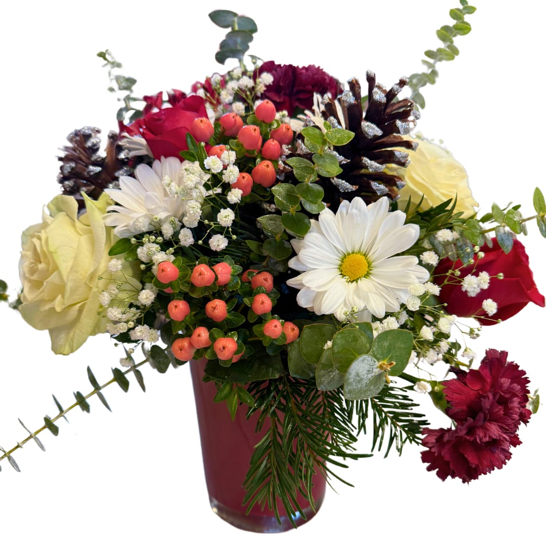 Frosted Forest Charm - Send the beauty of a winter wonderland with the Frosted Forest Charm arrangement. Featuring rich red and white roses, cheerful white daisies, and festive hypericum berries, this bouquet is accented with frosted pinecones, lush greenery, and eucalyptus for a touch of seasonal elegance. Arranged in a elegant red vase that can be reused as a decorative plant pot, this design evokes the magic of the holiday season and makes the perfect centerpiece or gift for spreading joy. Celebrate the warmth of winter with this stunning floral creation!