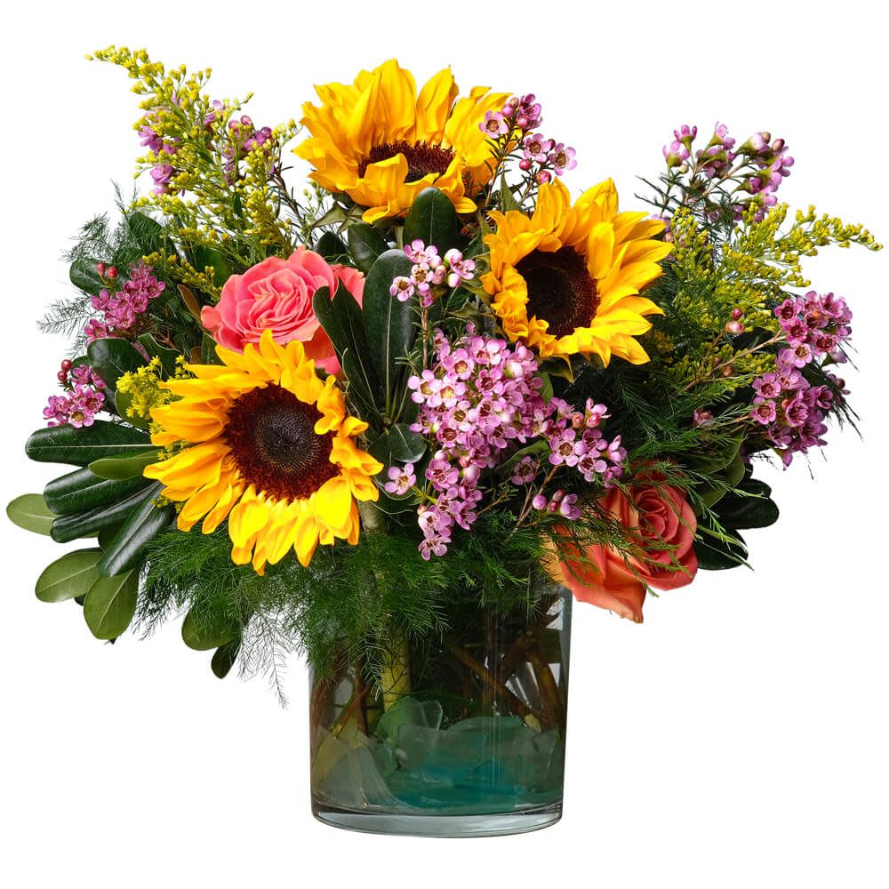 Fab You - Brightly colored flowers like roses, waxflower and sunflowers are complemented by dark green foliage. This design says, "You are fabulous!"