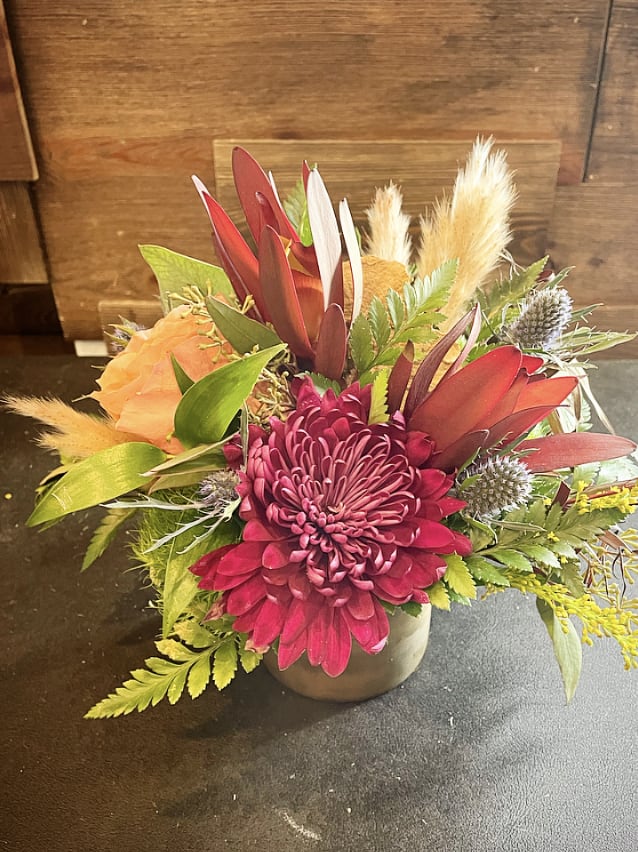 Nature Walk  - A small desk top like arrangement of plum chrysanthemums, Leucadendron, a nude shade rose, thistle and a mix of natural elements. Approx. 8&quot; Tall x 10&quot; Wide