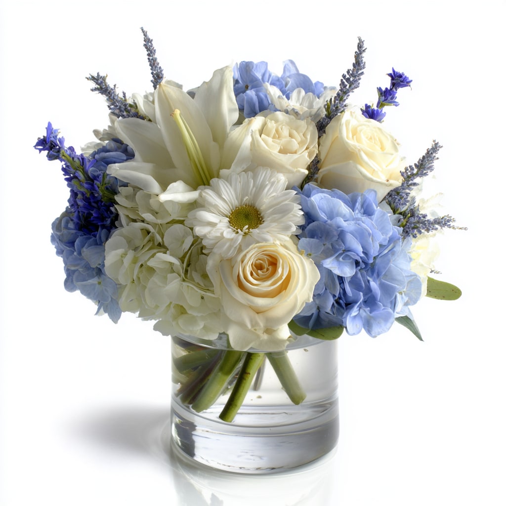 Shine Bright - Elevate any space with a fresh blue and white flower arrangement featuring lush blue and white hydrangea, elegant white roses, cheerful white daisies, and airy blue delphinium, hand‑arranged with mixed greenery. This serene bouquet offers cool, classic color and beautiful texture—perfect as a winter centerpiece, Hanukkah bouquet, sympathy arrangement, or thoughtful gift for birthdays and anniversaries.   Expertly crafted by our local florists, this hydrangea and delphinium bouquet delivers premium blooms, timeless style, and reliable delivery for any occasion.