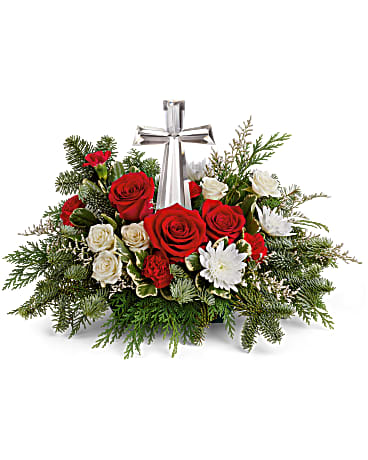 Joy of Light Bouquet - style by Teleflora - The crystal cross is nestled elegantly among red and white blooms, this keepsake brings joy and light to your special occasion. Red roses, white spray roses, red miniature carnations, white cushion spray chrysanthemums are adorned with white limonium, varigated pittosporum, noble fir, and cedar. Delivered with Teleflora's Crystal Cross Keepsake. Orientation: One-Sided 