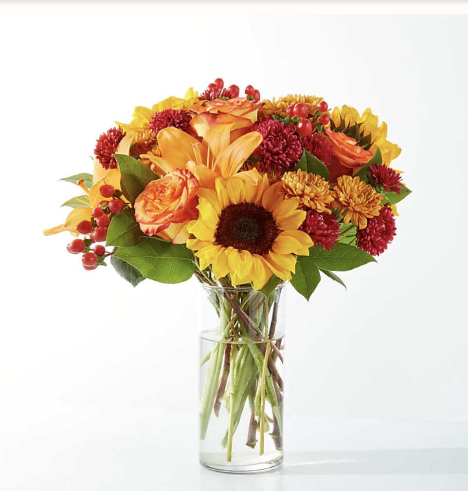 (F) Fall Day - Capturing the beauty of the season, the Fall Day Bouquet brings all the warmest tones with sunflowers, roses and lilies.  SUBSTITUTION POLICY Always deliver the freshest flowers! Please note the bouquet pictured reflects our original design.  If the exact flowers or container in this arrangement are not available, our local florists will create a beautiful bouquet with the freshest available flowers. 