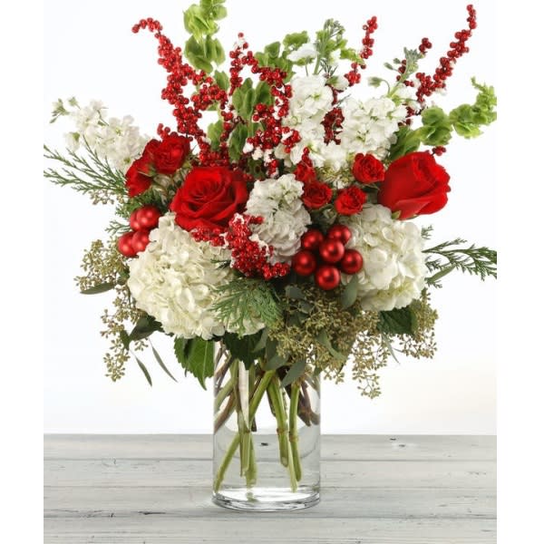 Winter Elegance - Perfect combination of holiday color of Red, White and Green with roses, stock, hydrangeas, and red berry branches. 