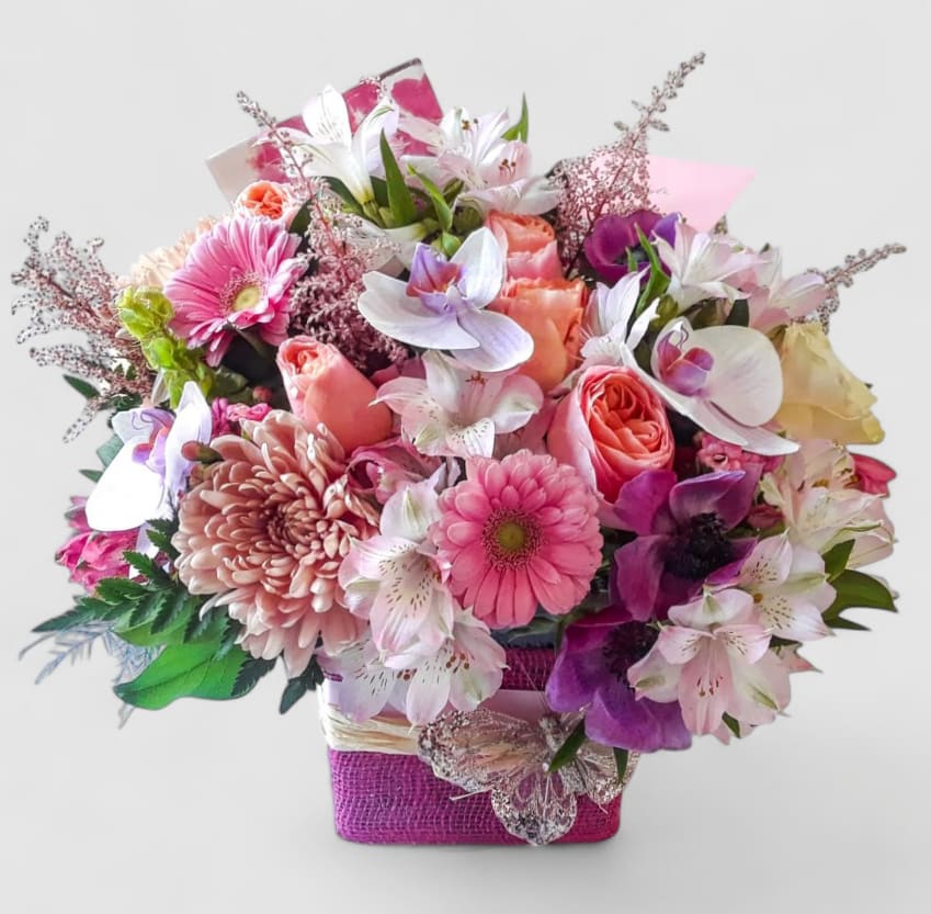 Bright Pink Beautiful Bouquet Designer's Choice - Send them a special gift to make them smile. Bright pink blossoms of roses orchids and more arranged in a modern glass cube vase wrapped in pretty pink jute ribbon. All fresh flower bouquets that leave my flower shop studio are works of art. Please visit my beautiful gallery to see my latest designs that I have created for my online customers. Send them a special bouquet to make them smile today.