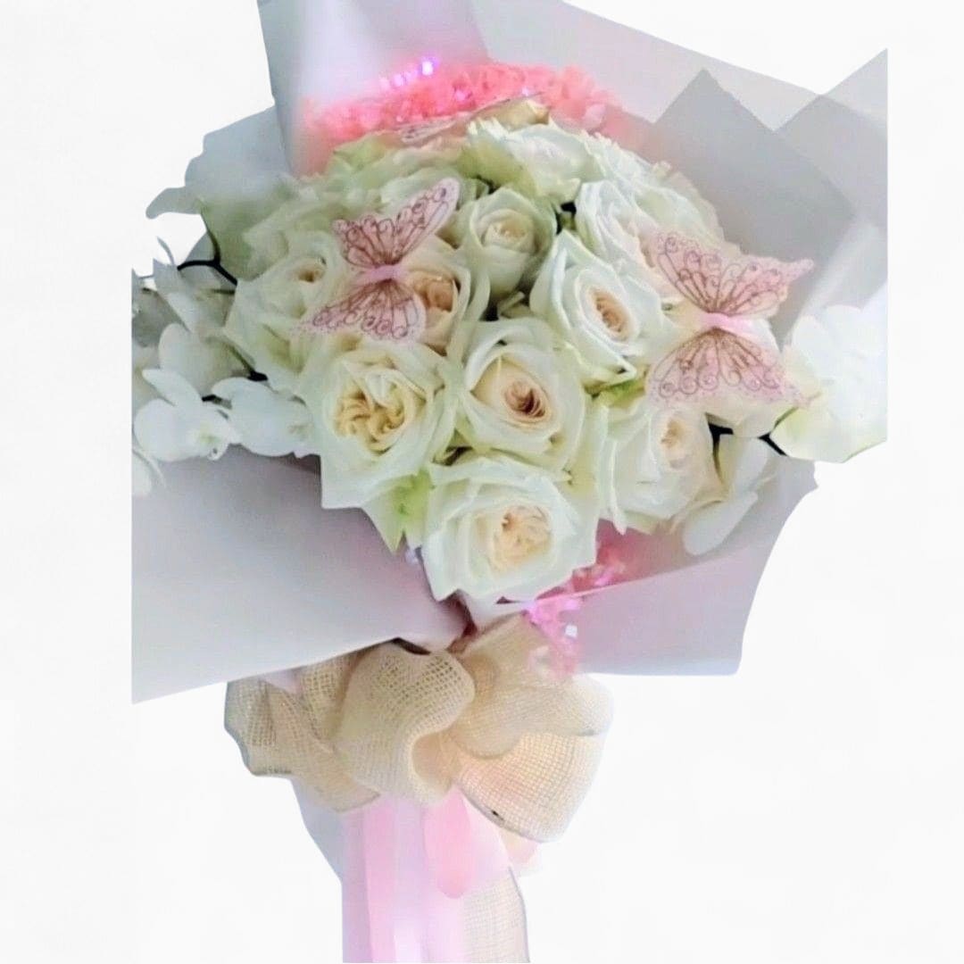 White Fashion Bouquet Designer's Choice - Roses orchids and more arranged as a presentation style bouquet wrapped in paper and long flowing ribbons. Stunning and perfect to present to someone to show them how much you care. All of my bouquets are always made extra special and unique each and every time. Please visit my gallery to see my latest designs. Send them happiness.