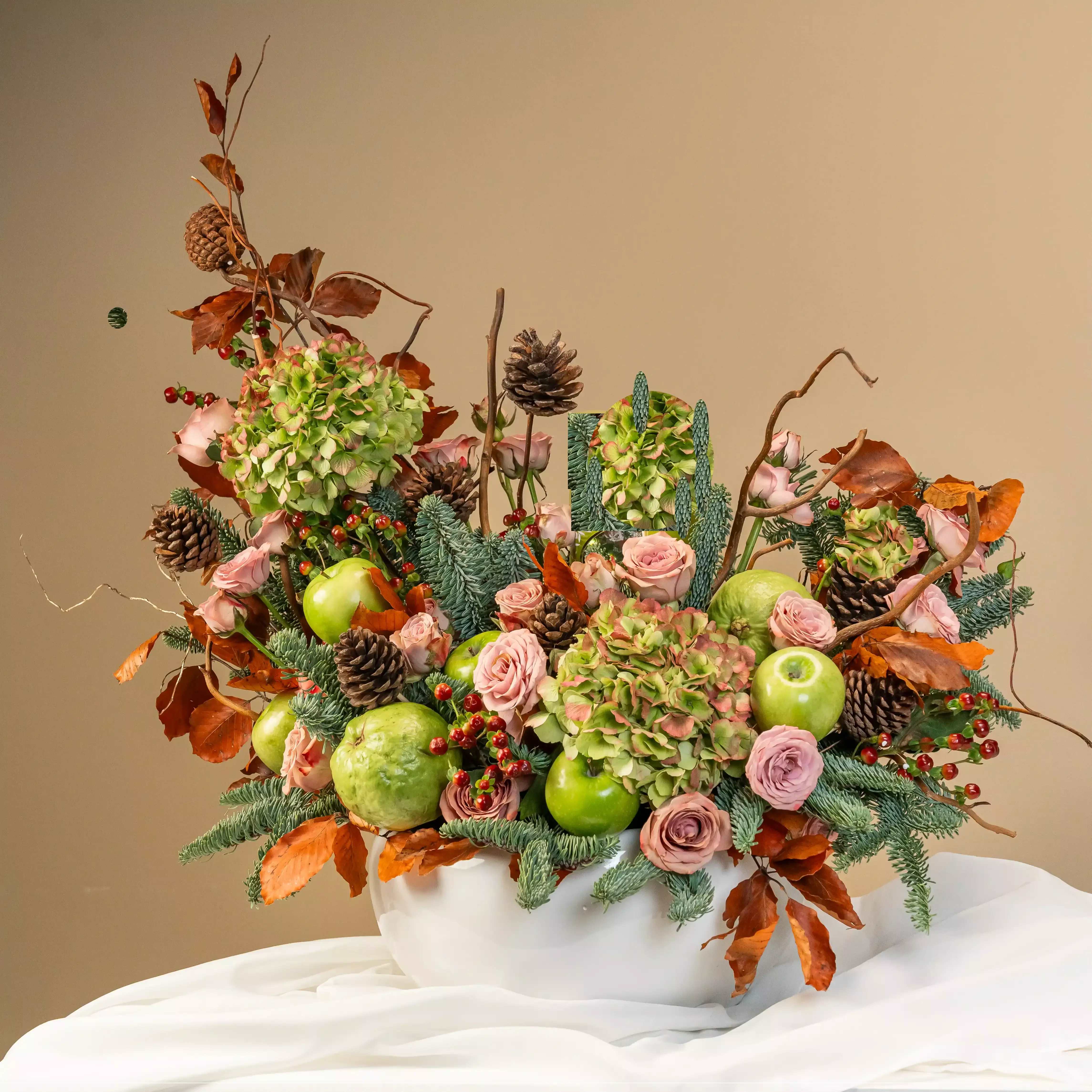 The Enchanted Winter Garden - The mix of fresh green apples and soft pink florals conveys abundance, harmony, and gratitude. Pine cones and rustic foliage bring the warmth of a woodland Christmas, a touch of indulgence—perfect for sharing festive joy and comfort.