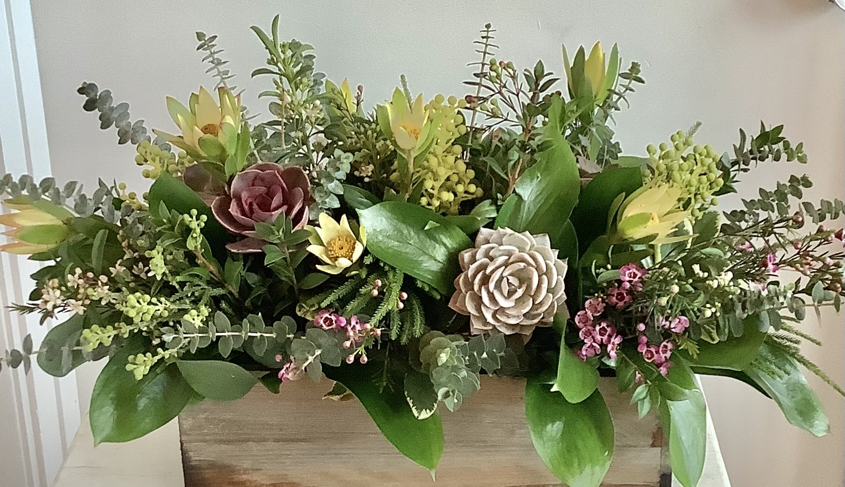 English Garden by BloomNation™ - When spending the summer in an english country estate with Jane Austen or the royal family isn't an option, English Garden by BloomNation™ is the next best thing. This long lasting centerpiece style arrangement features a variety of greenery, natural flowers, succulents and berries.  APPROXIMATE DIMENSIONS 22&quot; W X 10&quot; H