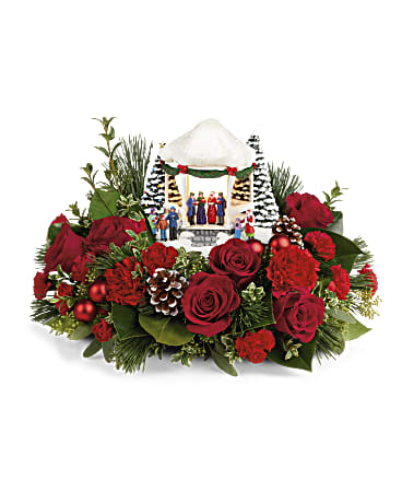 Thomas Kinkade's Sweet Sounds Of Christmas - Here's something to sing about! This charming, hand-painted Thomas Kinkade collectible is nestled in festive red roses and winter greens for an unforgettable gift. The classic caroling scene lights up for extra holiday fun.