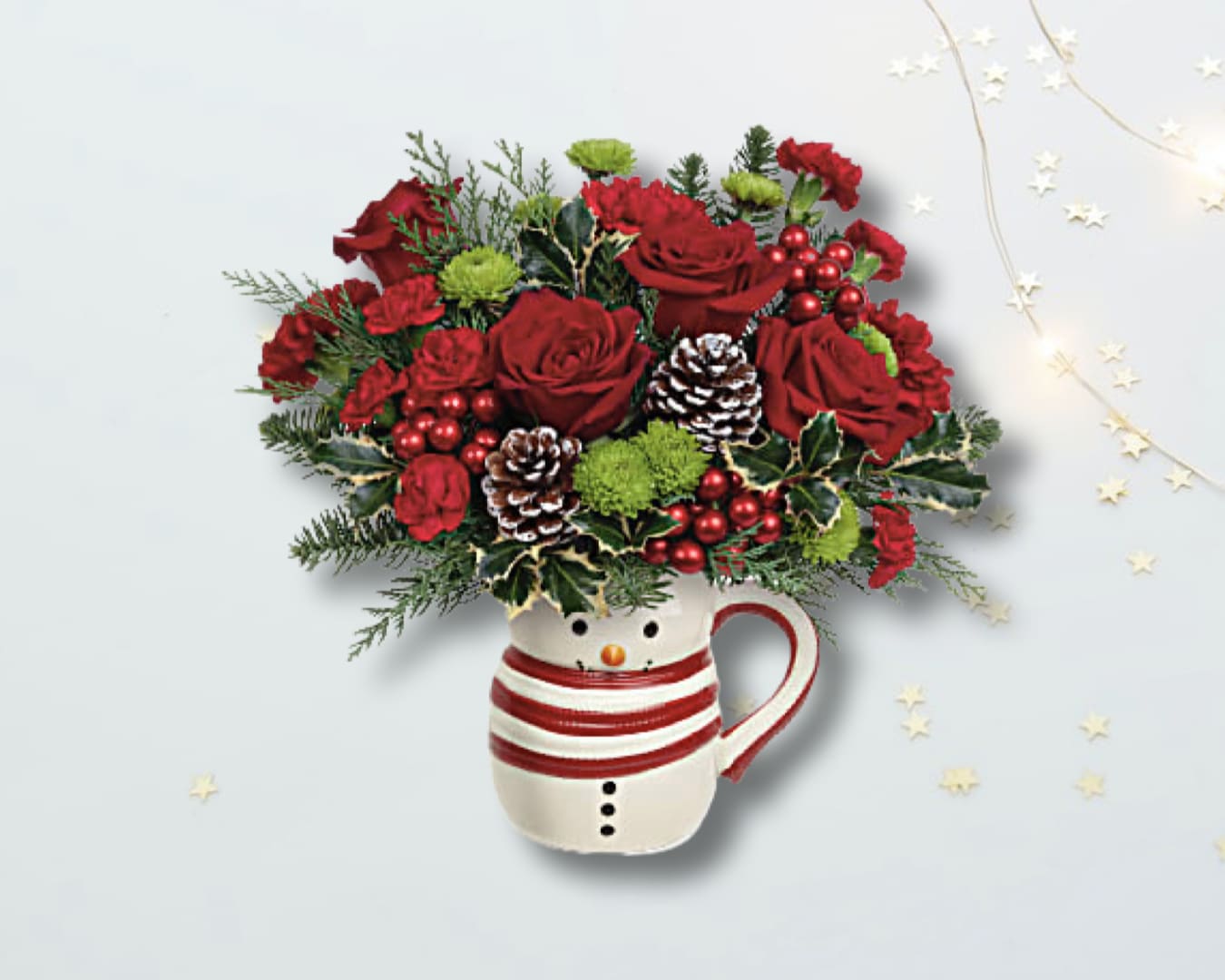 Send A Hug® Sweet Frosty Bouquet - Whether filled with festive flowers for Christmas or hot cocoa in the New Year, this smiling sweet frosty snowman mug vase spreads whimsical winter cheer. Order these Christmas flowers and put a smile on your loved one's face. Red carnations, miniature red carnations and green button spray chrysanthemums are arranged with noble fir, cedar and variegated holly. This Christmas bouquet is delivered in Teleflora's Send a Hug® Sweet Frosty Mug.