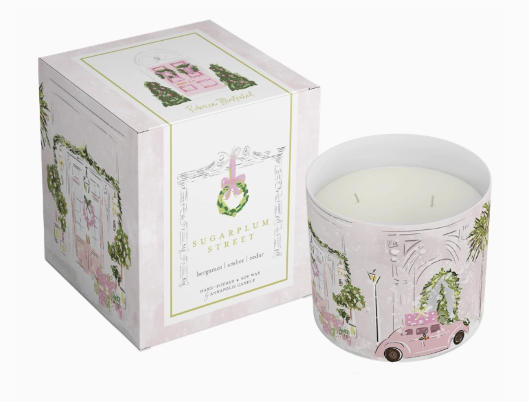 Holiday Sugar Plum Lane 2-Wick Gift Boxed Candle - Step into the charm of Holly House, a holiday collection brought to life by Charleston-based artist Rebecca Meixner. From twinkling lights, festive wreaths and candy-colored rooftops, this trio of soy-based candles is a joyful tribute to the holiday spirit. With nostalgic fragrances, Holly House is a warm invitation to celebrate being home for Christmas! Fragrance notes for this 2-wick, vegetable wax candle include bergamot, amber and cedar.  Made in the USA